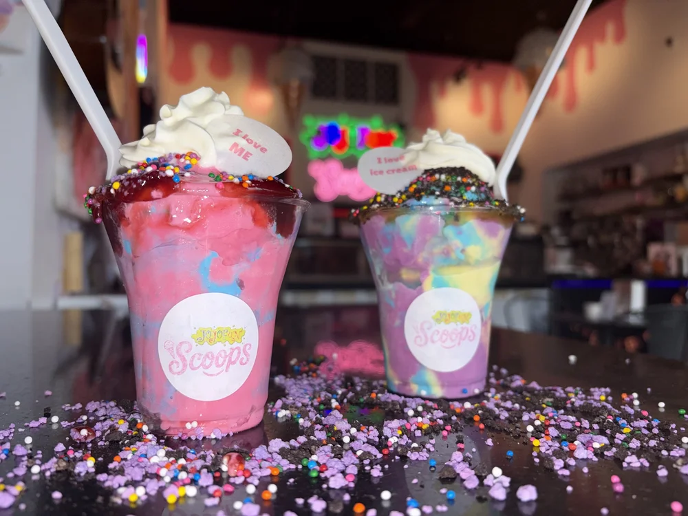Two colourful JoJoFun Scoops sundaes with whipped cream and toppings