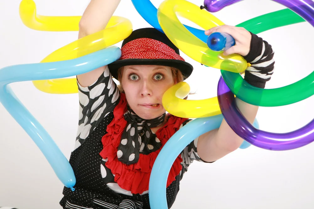 JoJoFun entertainer surrounded by colourful twisting balloons