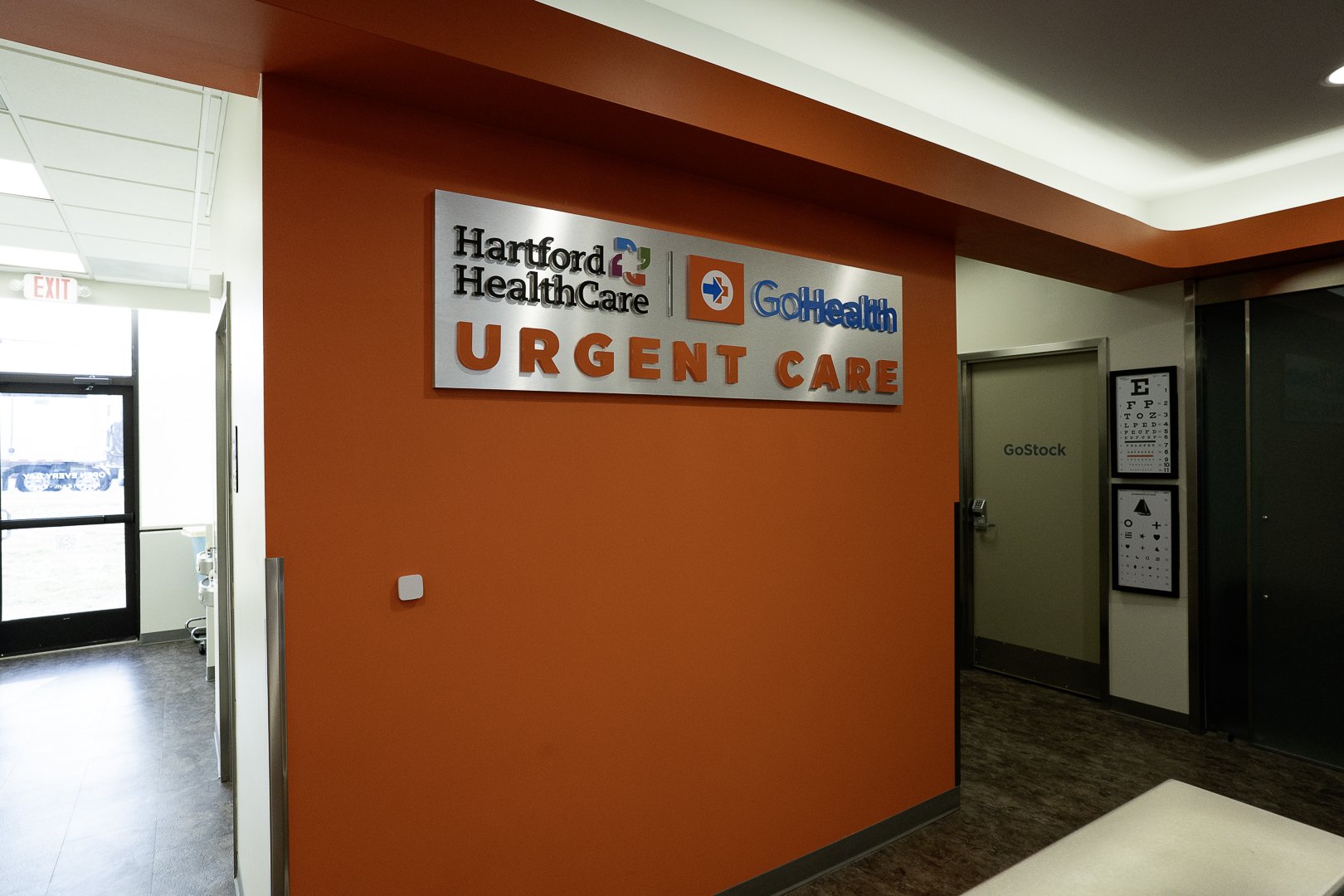 Sign for Hartford Healthcare and GoHealth urgent care in a medical facility.