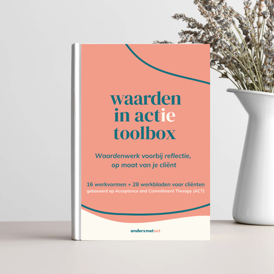 Een boek met de titel 'waarden in actie toolbox' ligt op een tafel naast een vaas met gedroogde bloemen.