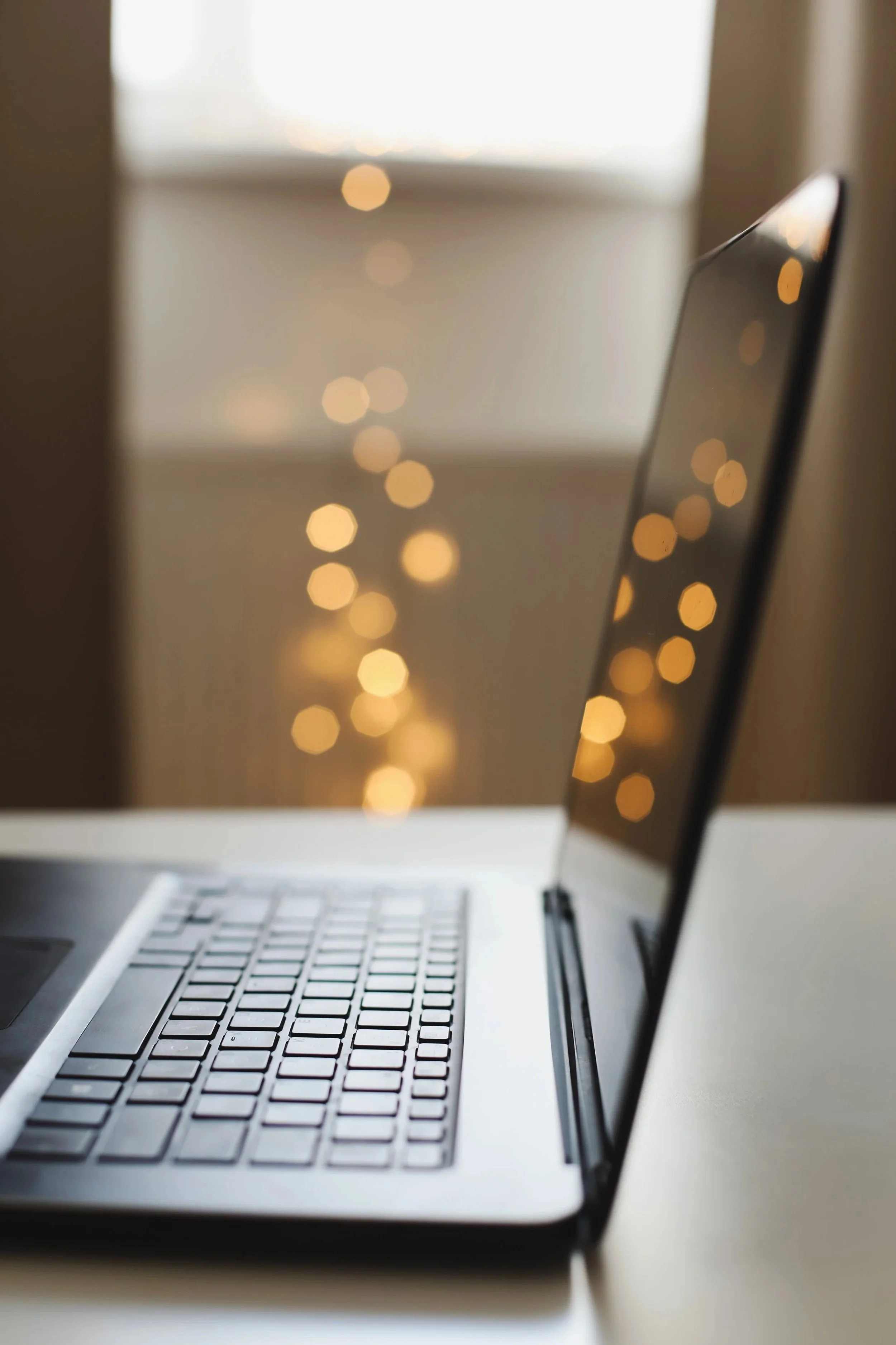 Laptop on a desk in a calm, softly lit workspace