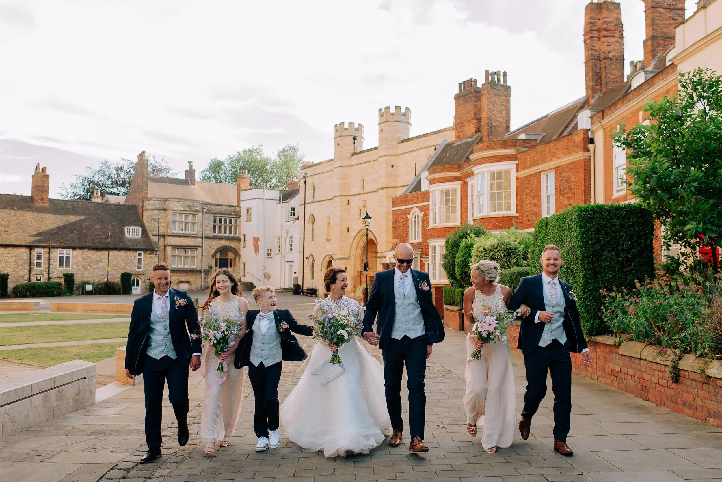 Wedding group walking through lincoln bailgate