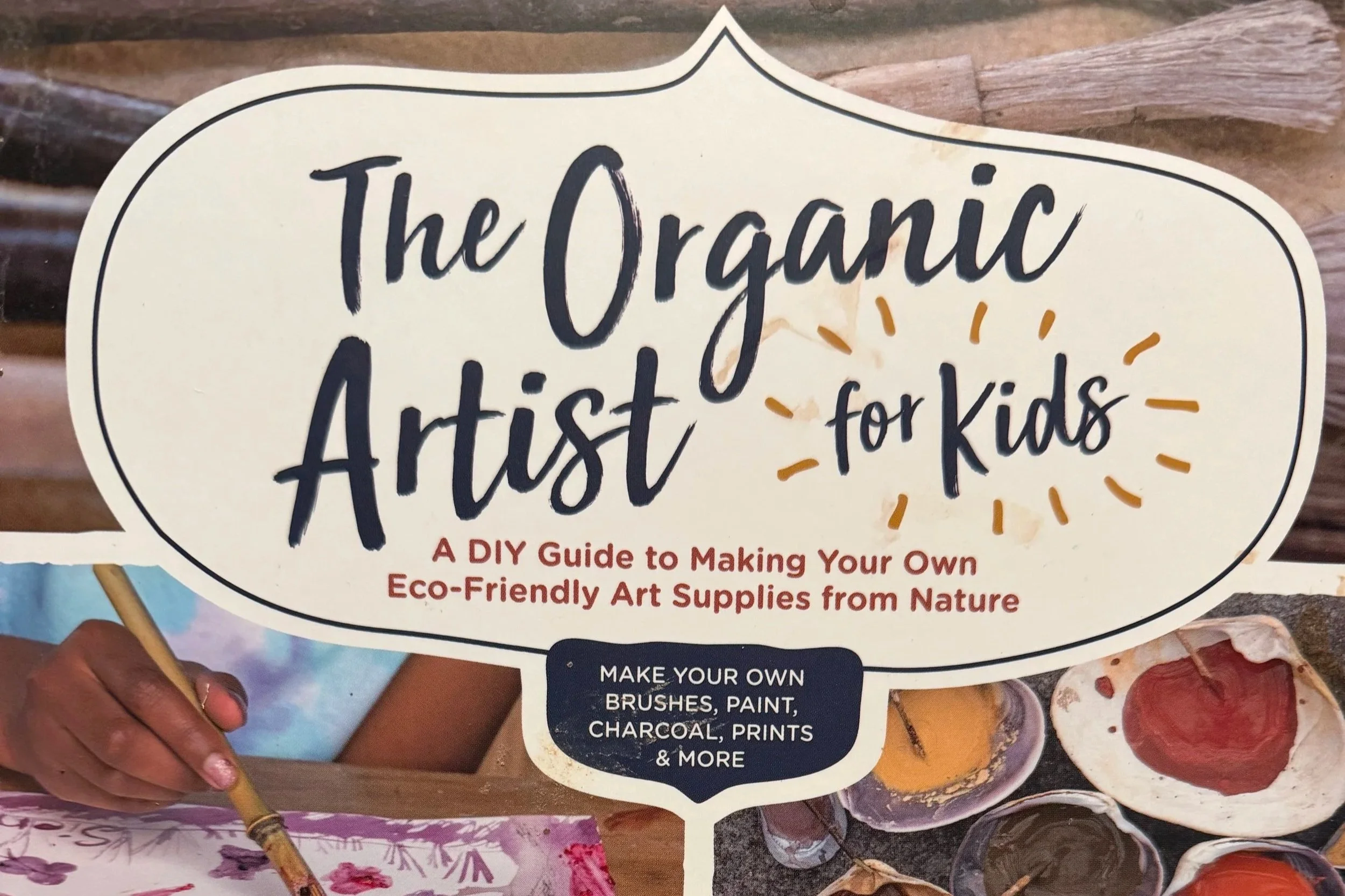 A group of children holding hands and raising their arms on a stage, during a theatrical performance or school play.