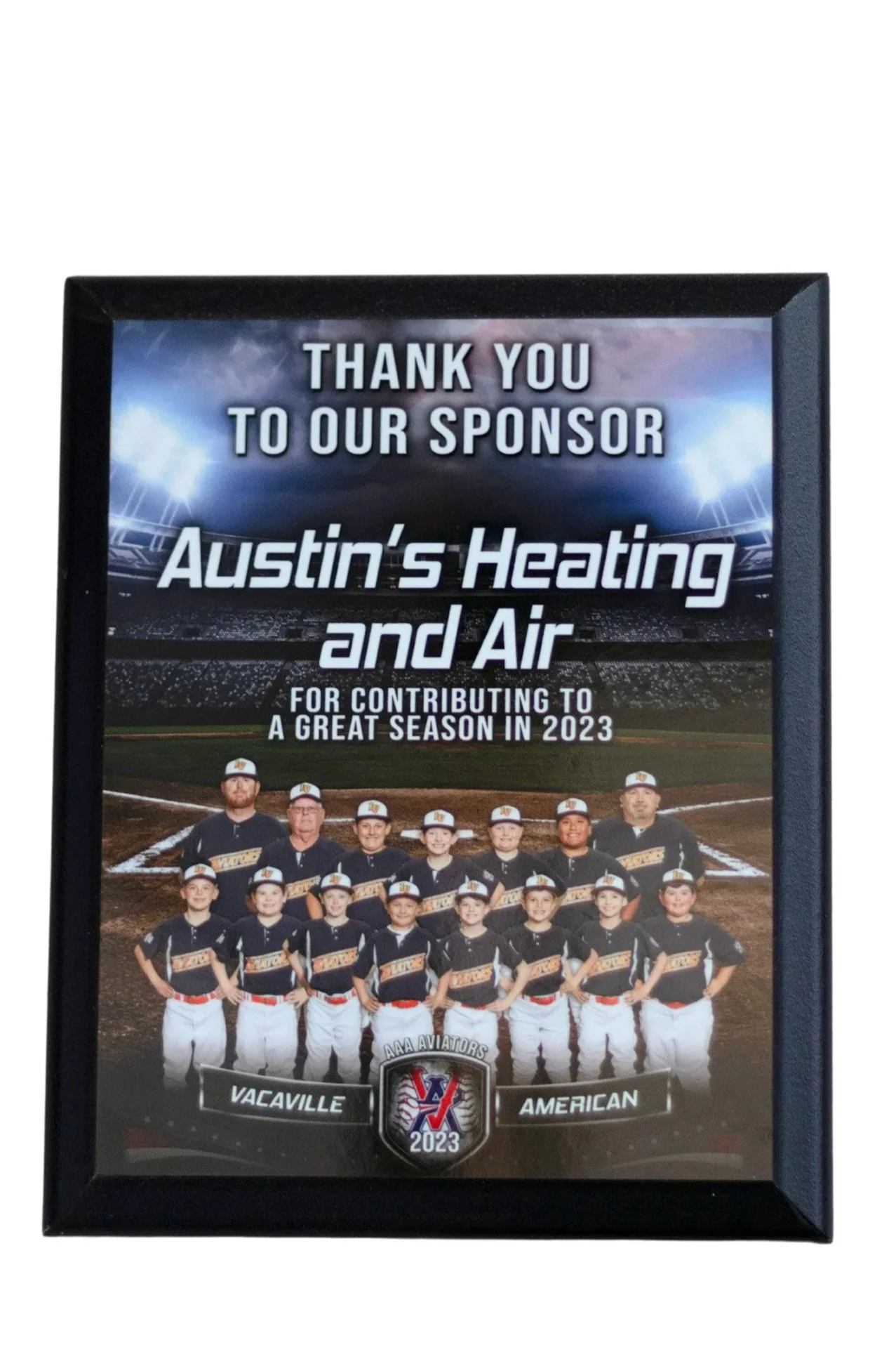 Framed thank you poster featuring a baseball team with players and coaches, acknowledging Austin's Heating and Air for contributing to a successful 2023 season, with the team name "Vacaville American" and a logo at the bottom center.