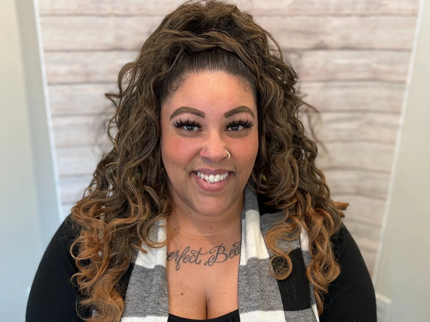 Victoria Carroll smiling in professional portrait against light wooden backdrop, representing Cocoon House team in Snohomish County