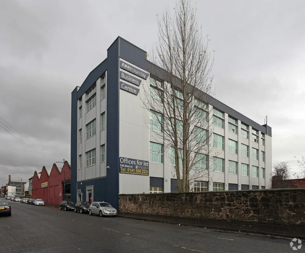 A multi-story commercial building labelled 'Abercromby Business Centre' located in Glasgow, with street parking available outside.