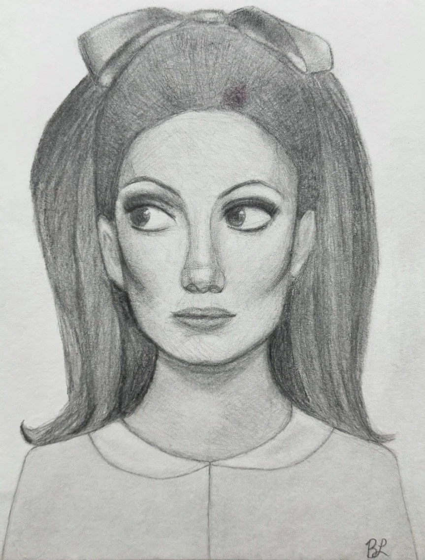 A detailed pencil drawing of a woman with large eyes, full lips, and long, styled hair, wearing a collared top, with a bow or ribbon in her hair.