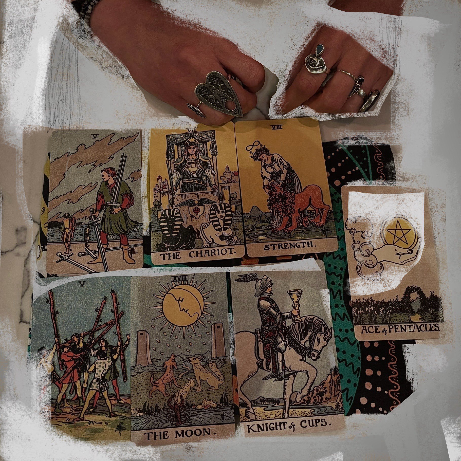 Tarot cards are laid out on a table and spread cloth during a tarot card reading.