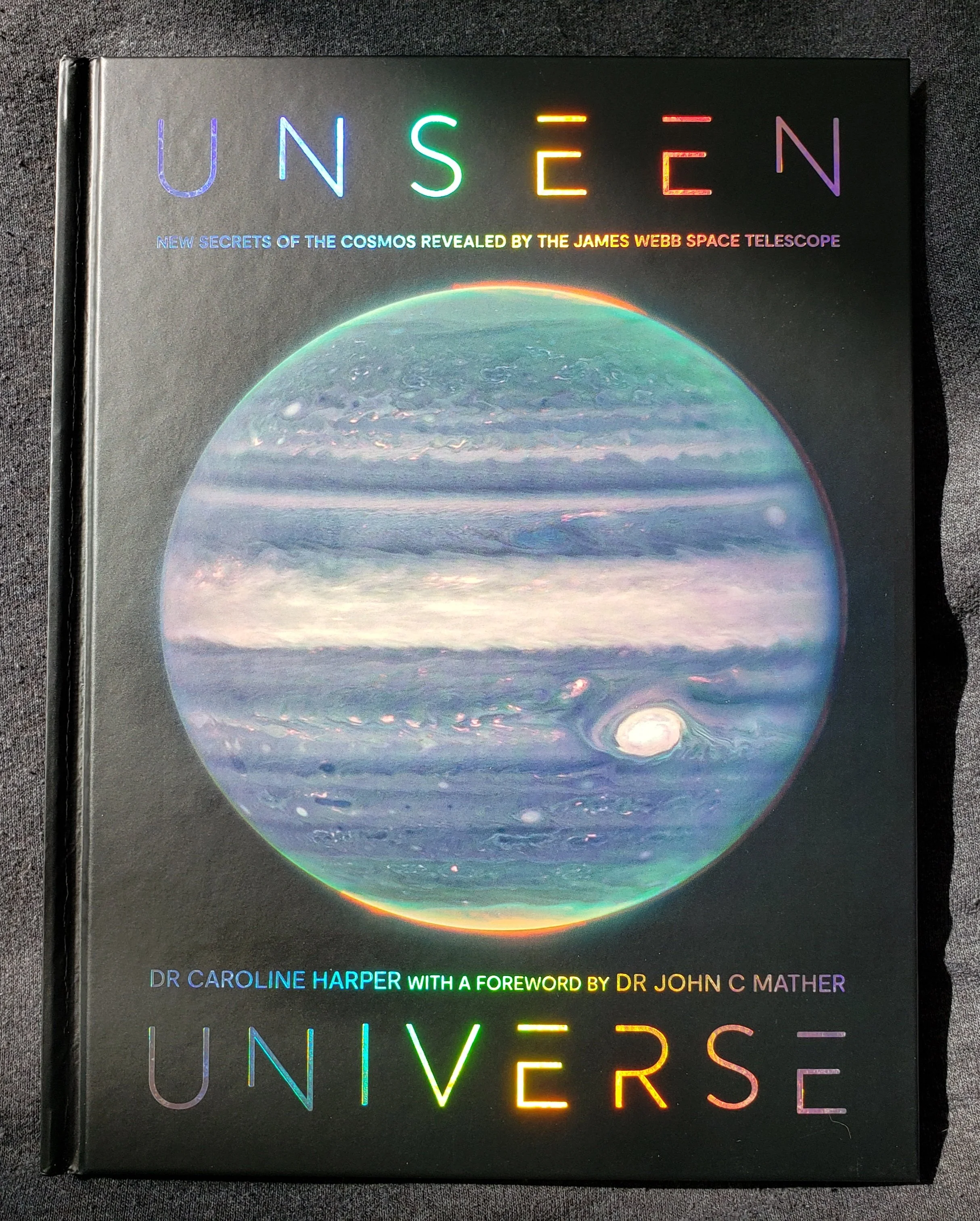 Unseen Universe book cover showing Jupiter in the iridescent greens, blues, and purples against a black background.