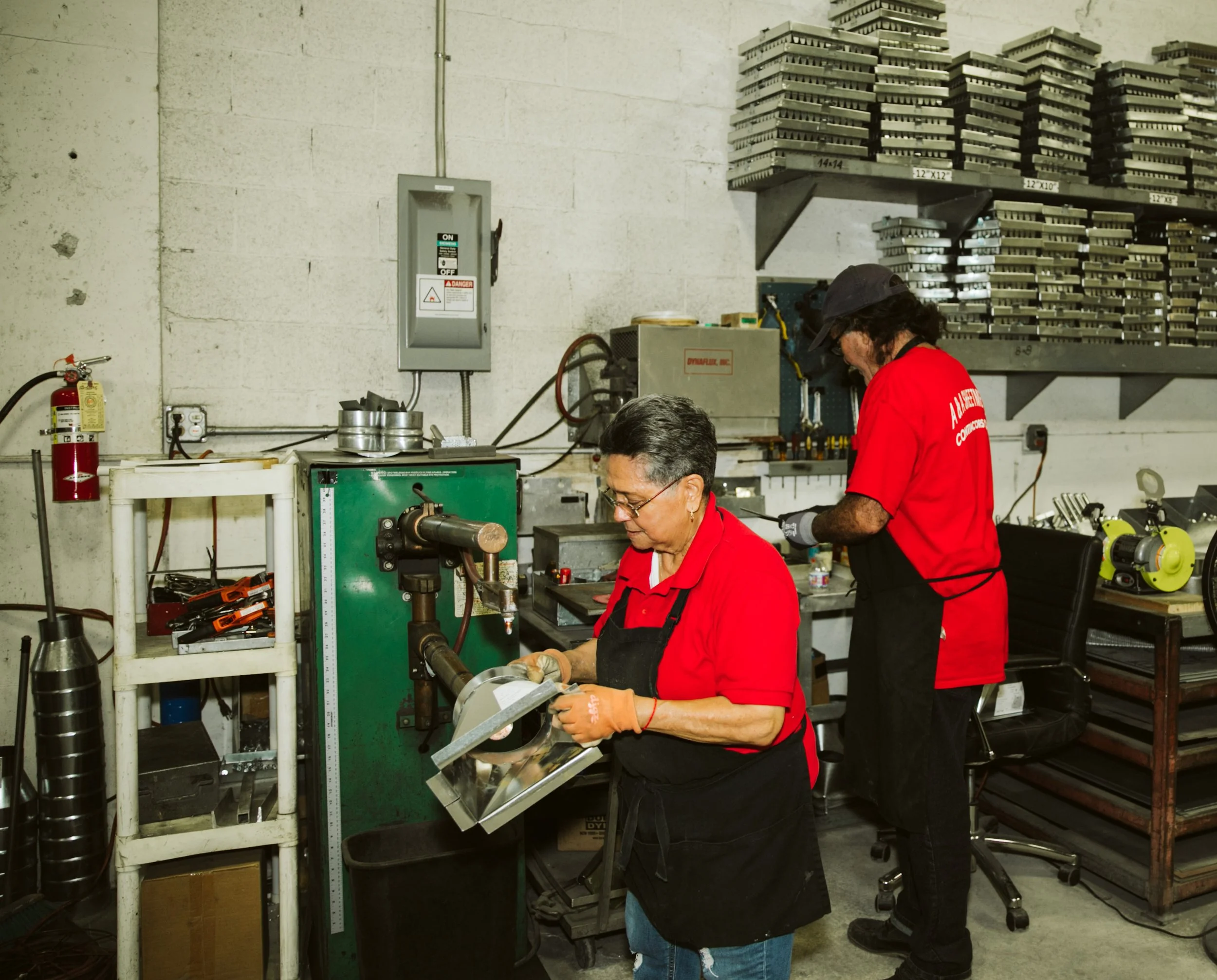 Team of sheet metal workers operating machinery during commercial photoshoot