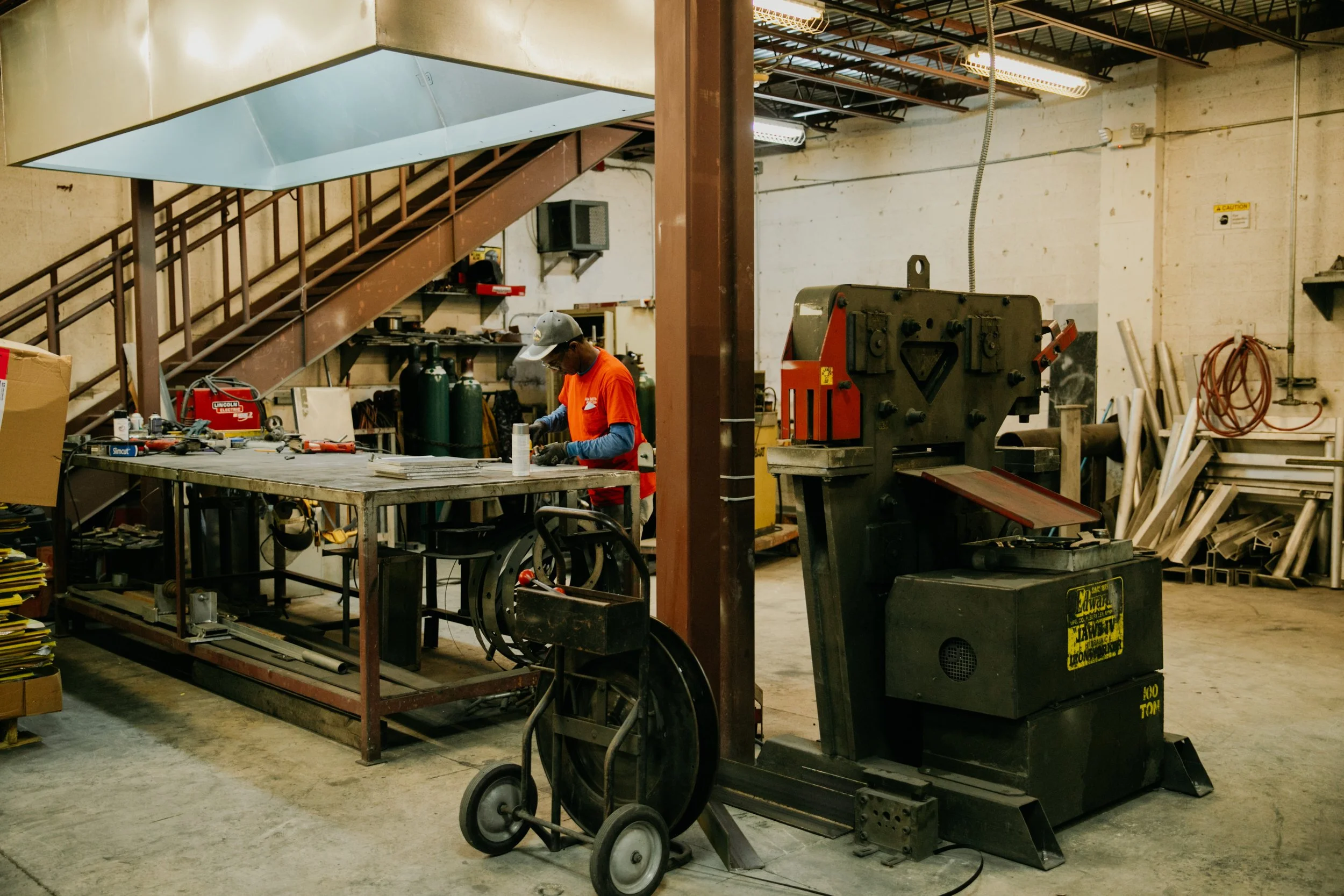 Team of sheet metal workers operating machinery during commercial photoshoot