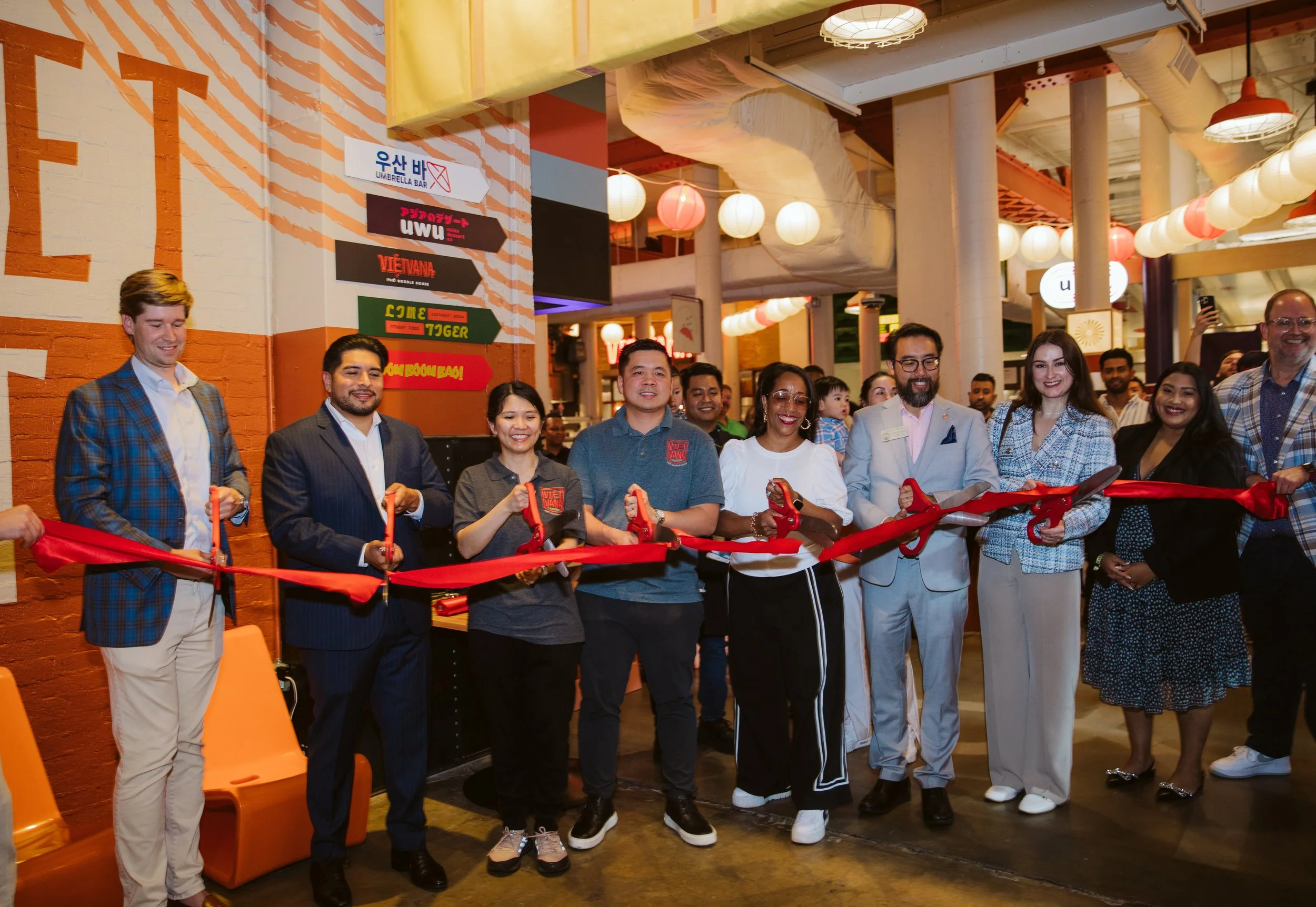 Group of attendees or team behind Market East smiling at the launch event.