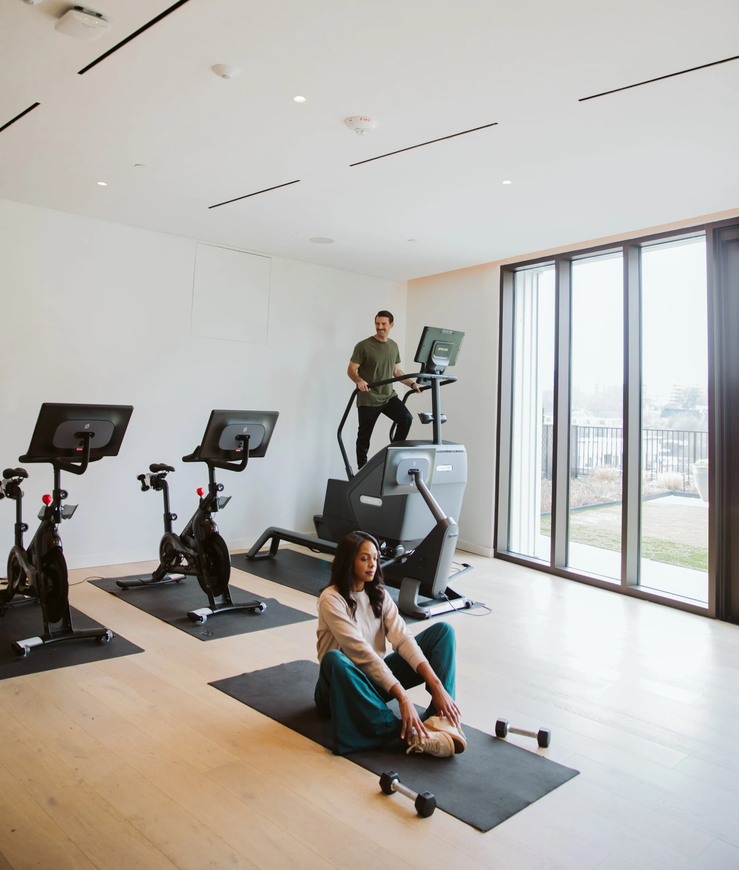 Apartment fitness studio with bikes and exercise equipment