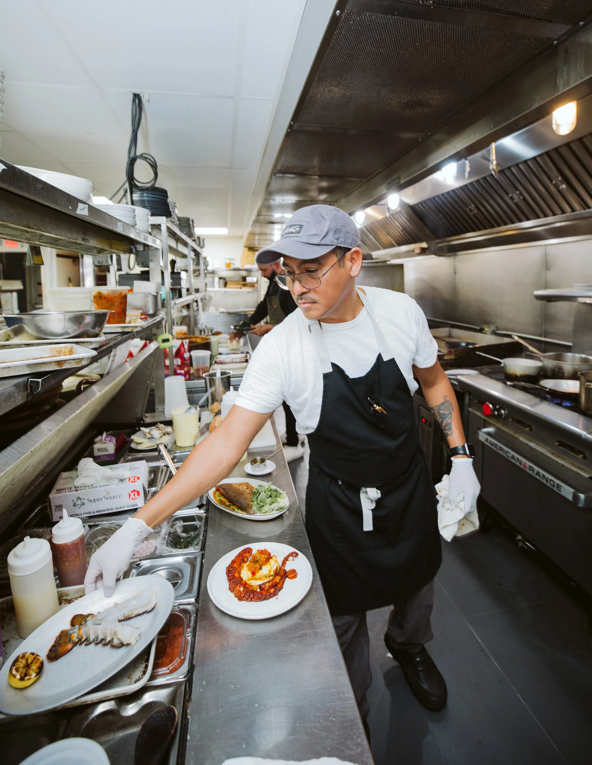 Chef plating food in professional restaurant kitchen