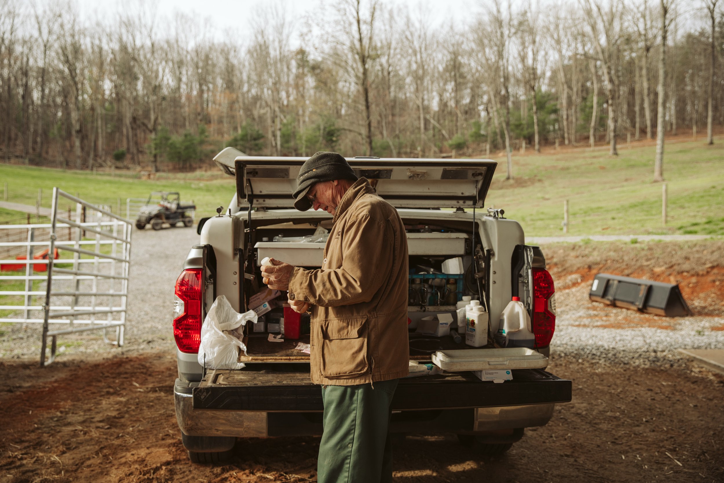 Farmer at truck bed with supplies