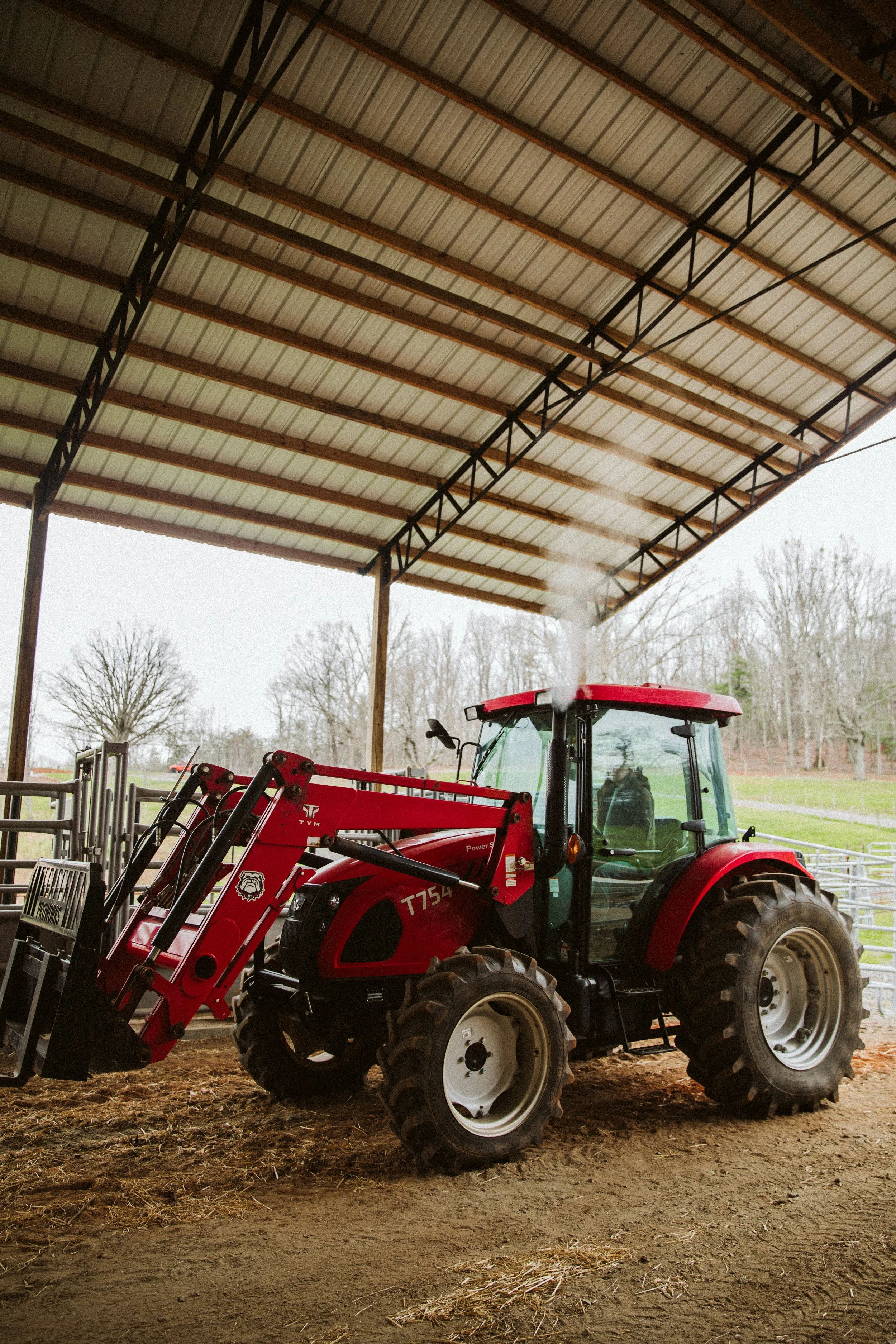 Red tractor inside barn