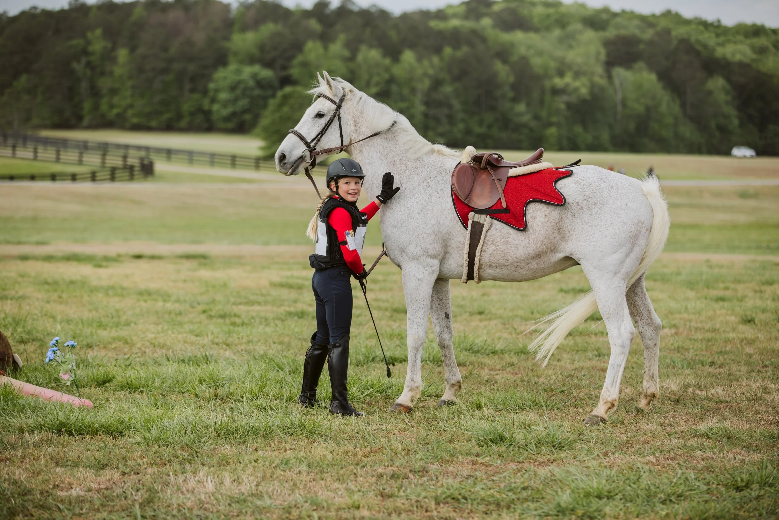 Child with grey horse at horse show