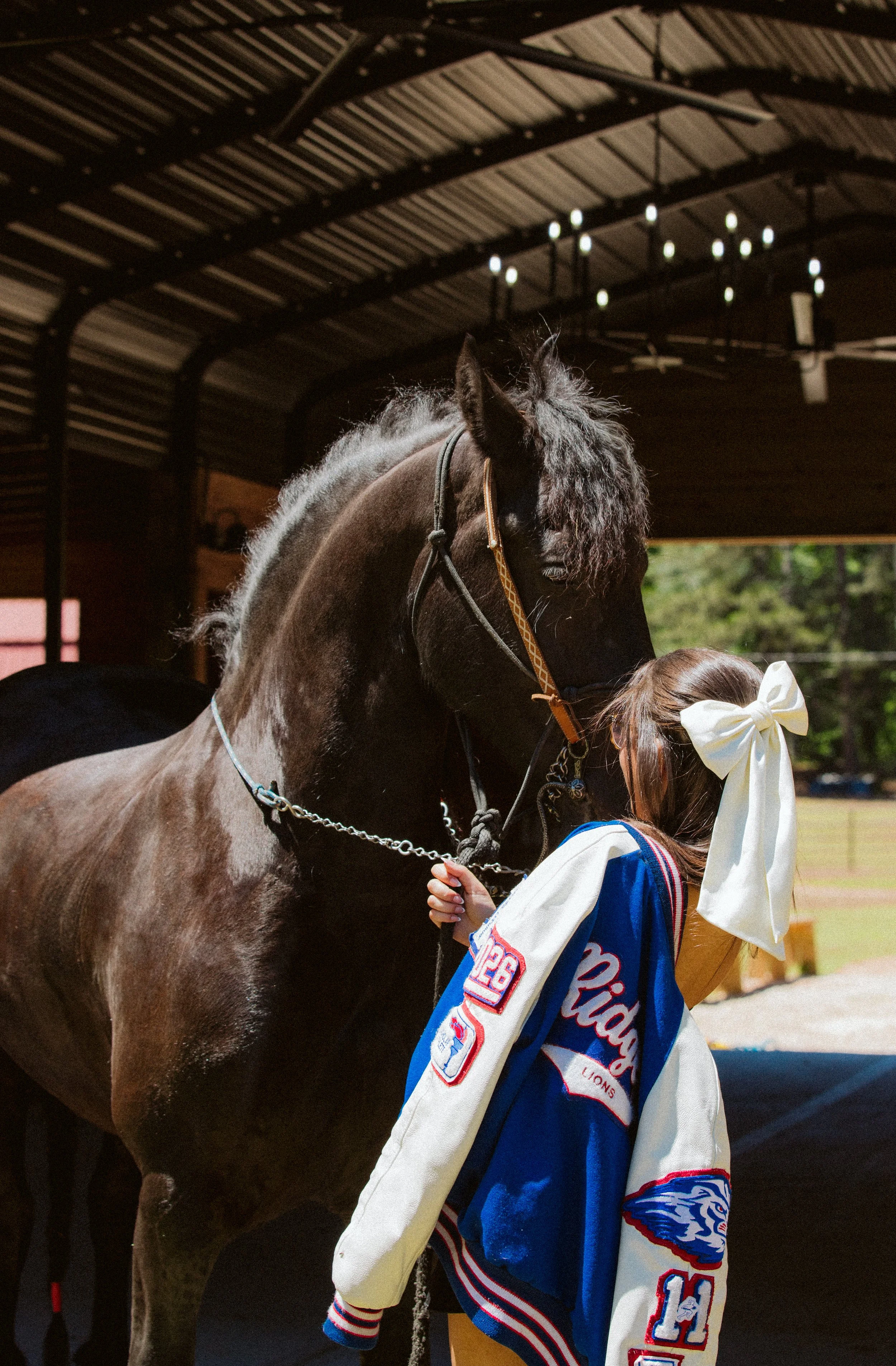 Graduate with horse in barn senior portraits