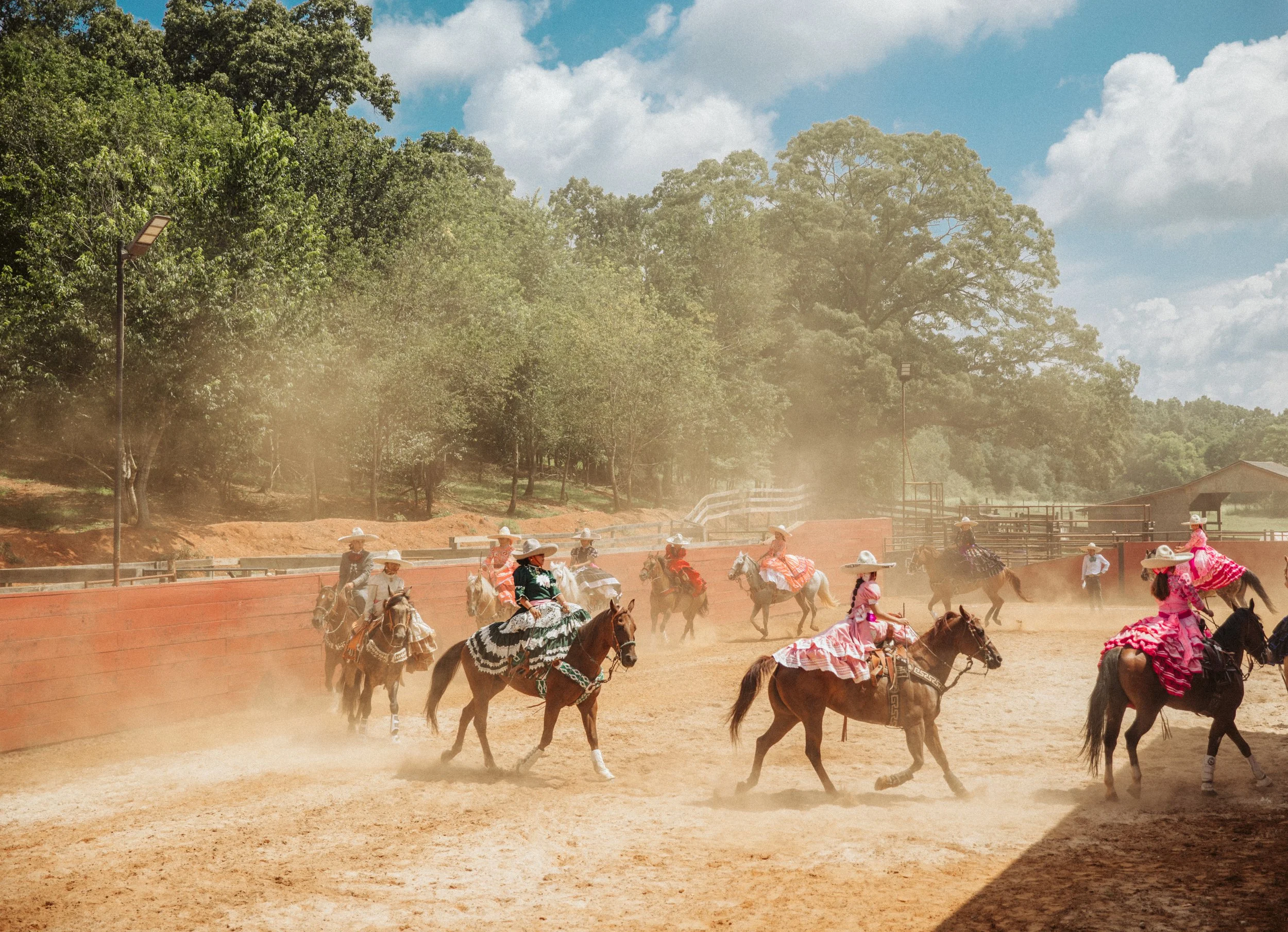 scaramuza riders performing in dusty arena