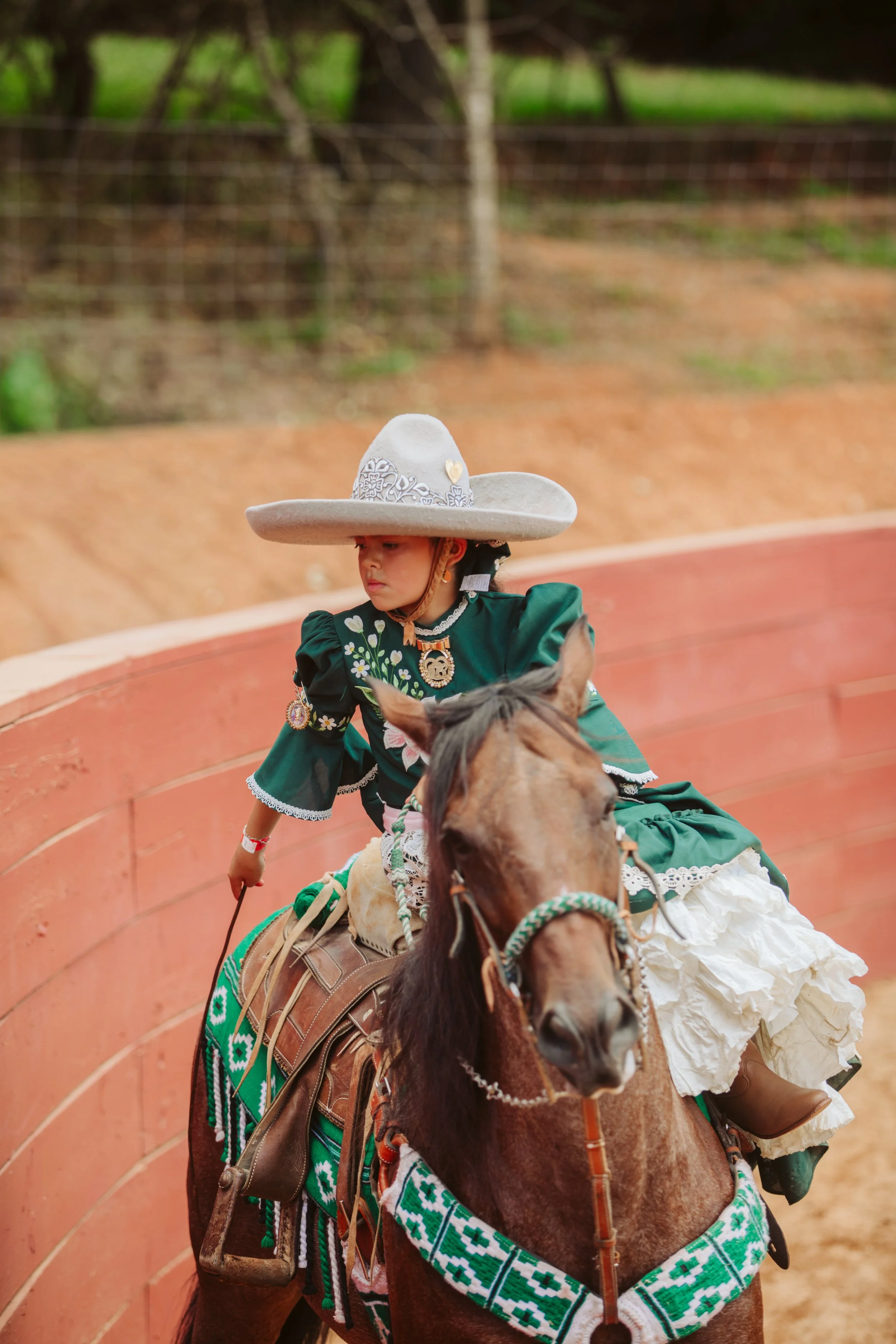 Escaramuza rider in green charra dress