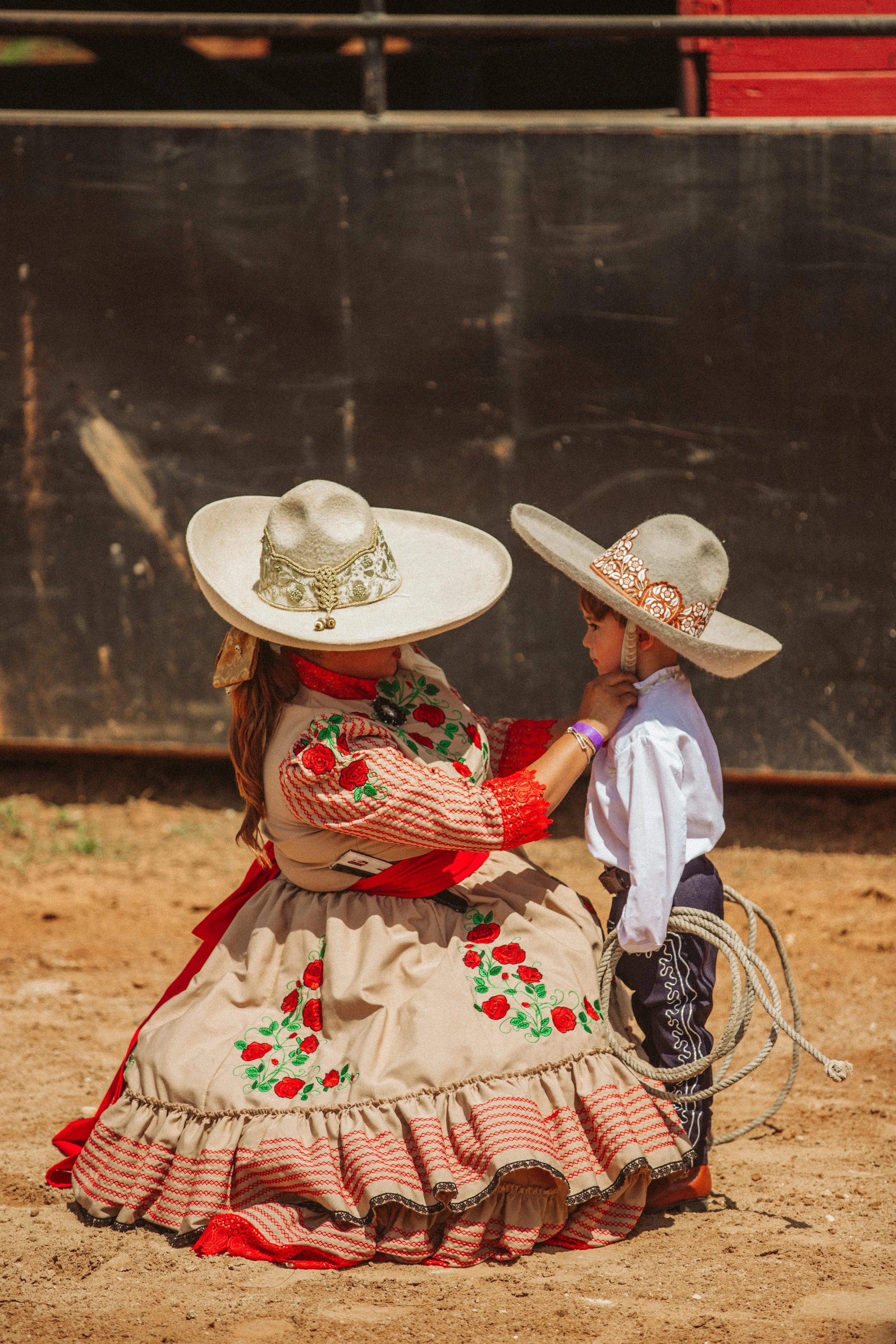 Charra teaching young cowboy
