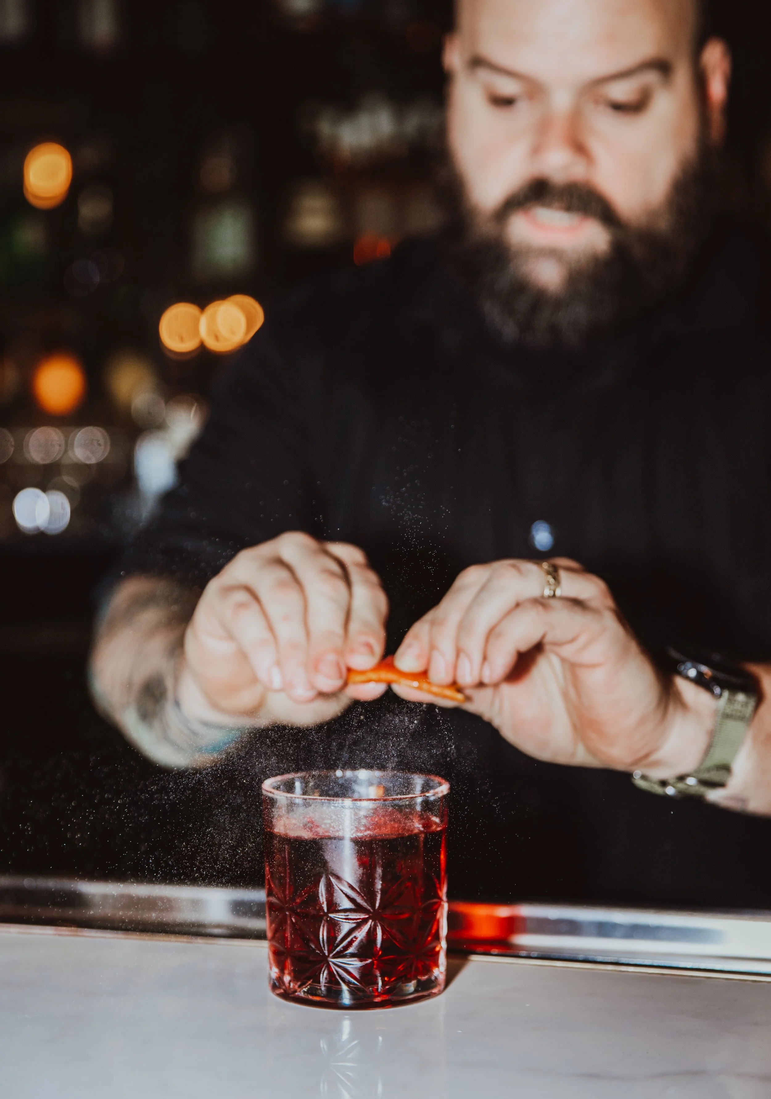 Editorial food and beverage photography featuring a styled cocktail and plated dish in a modern Atlanta restaurant.