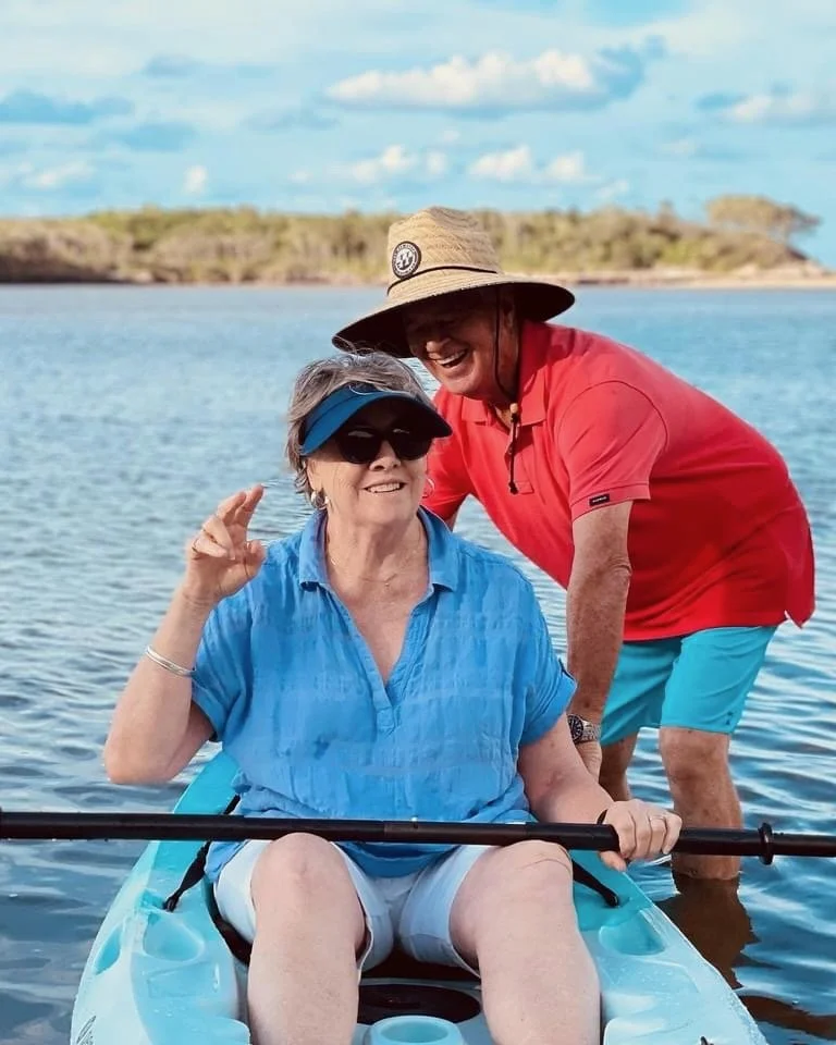 Older couple enjoying an active lifestyle kayaking on the water in Brisbane