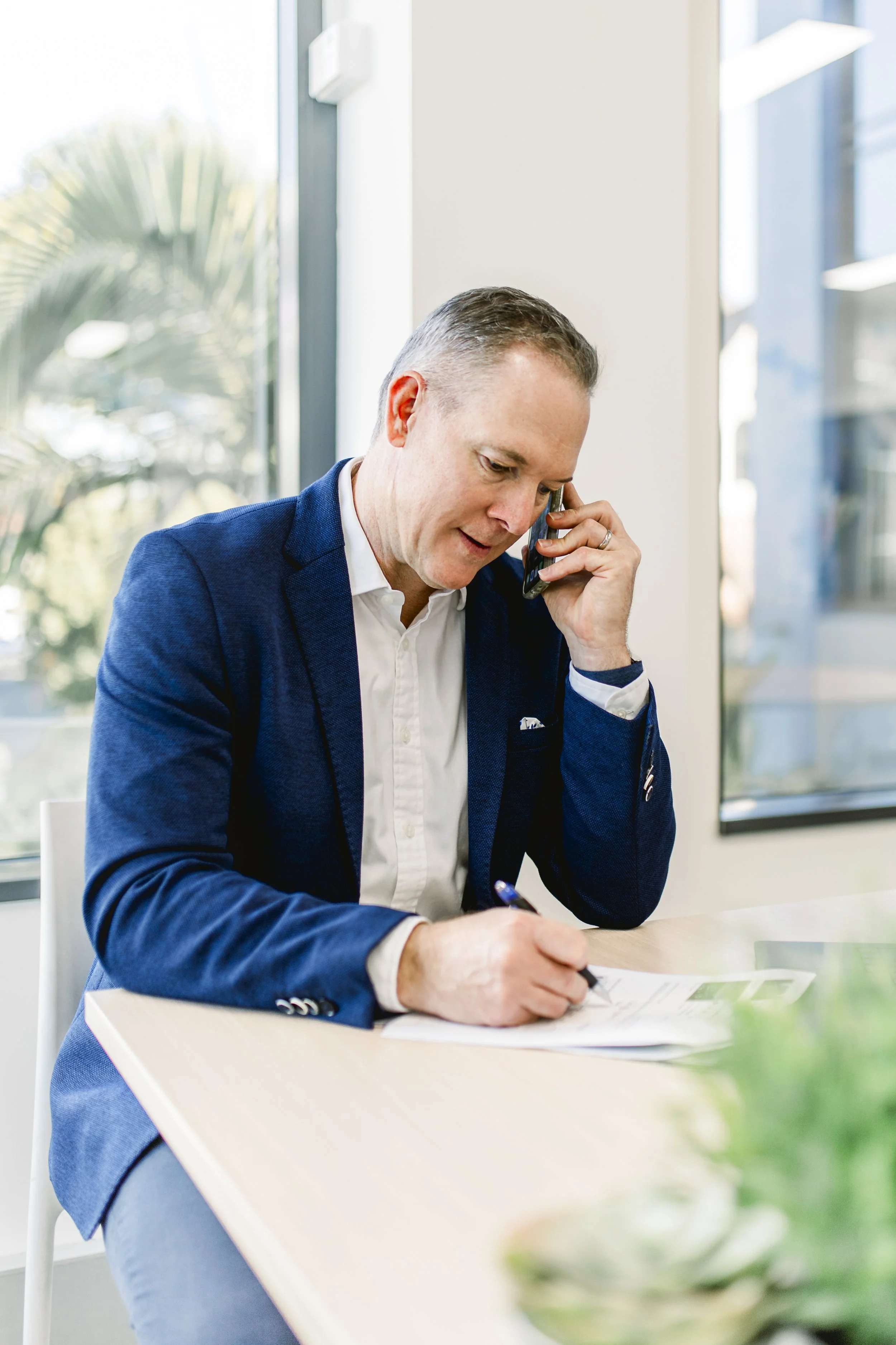 Sam Price taking a call from a client re a retirement village.
