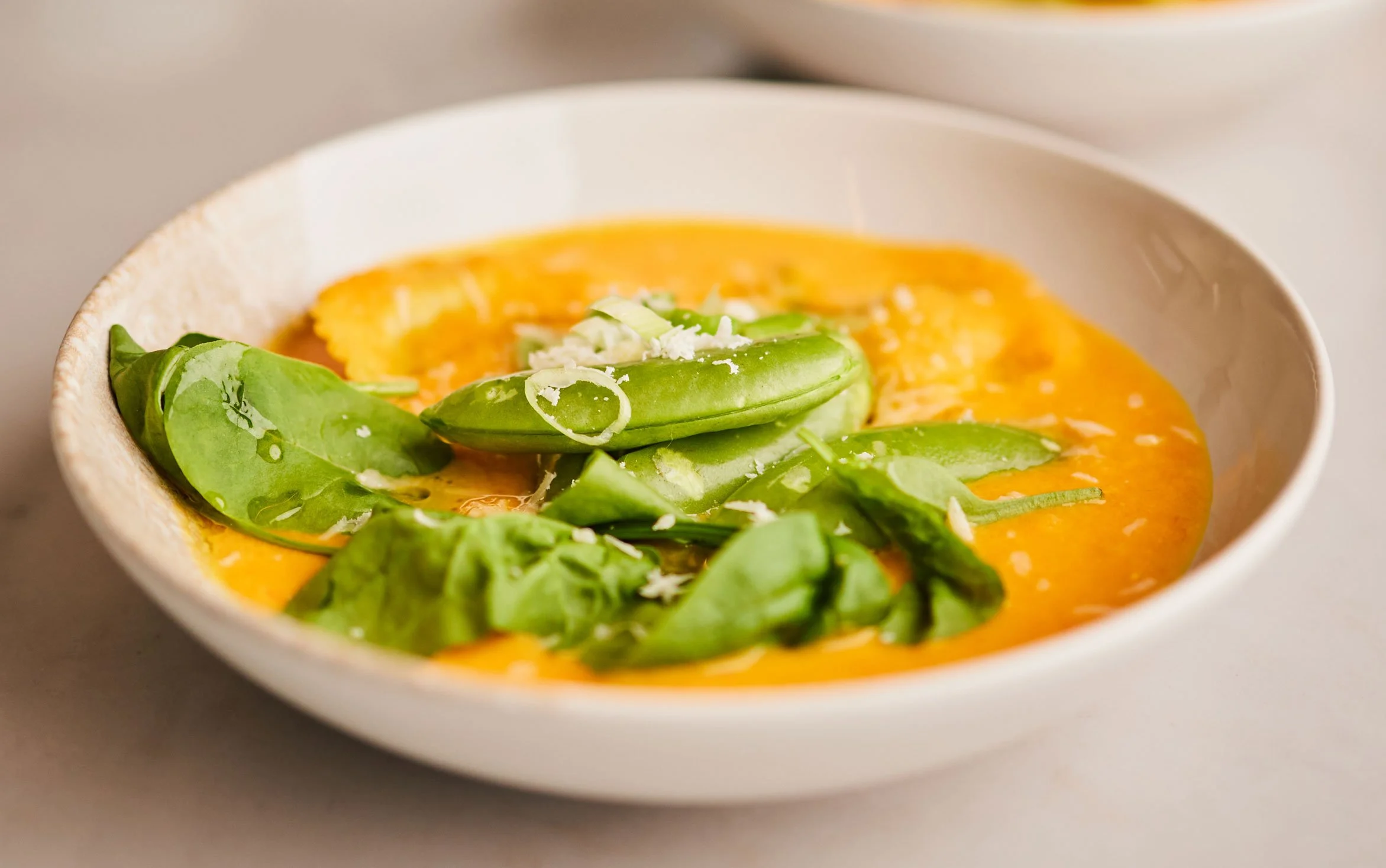 Gulrot- og søtpotetsuppe med ravioli, sukkererter og spinat