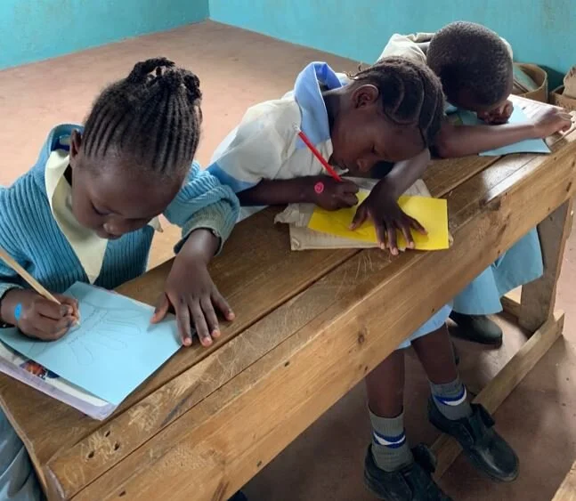 Three Students Studying at One Desk.JPG