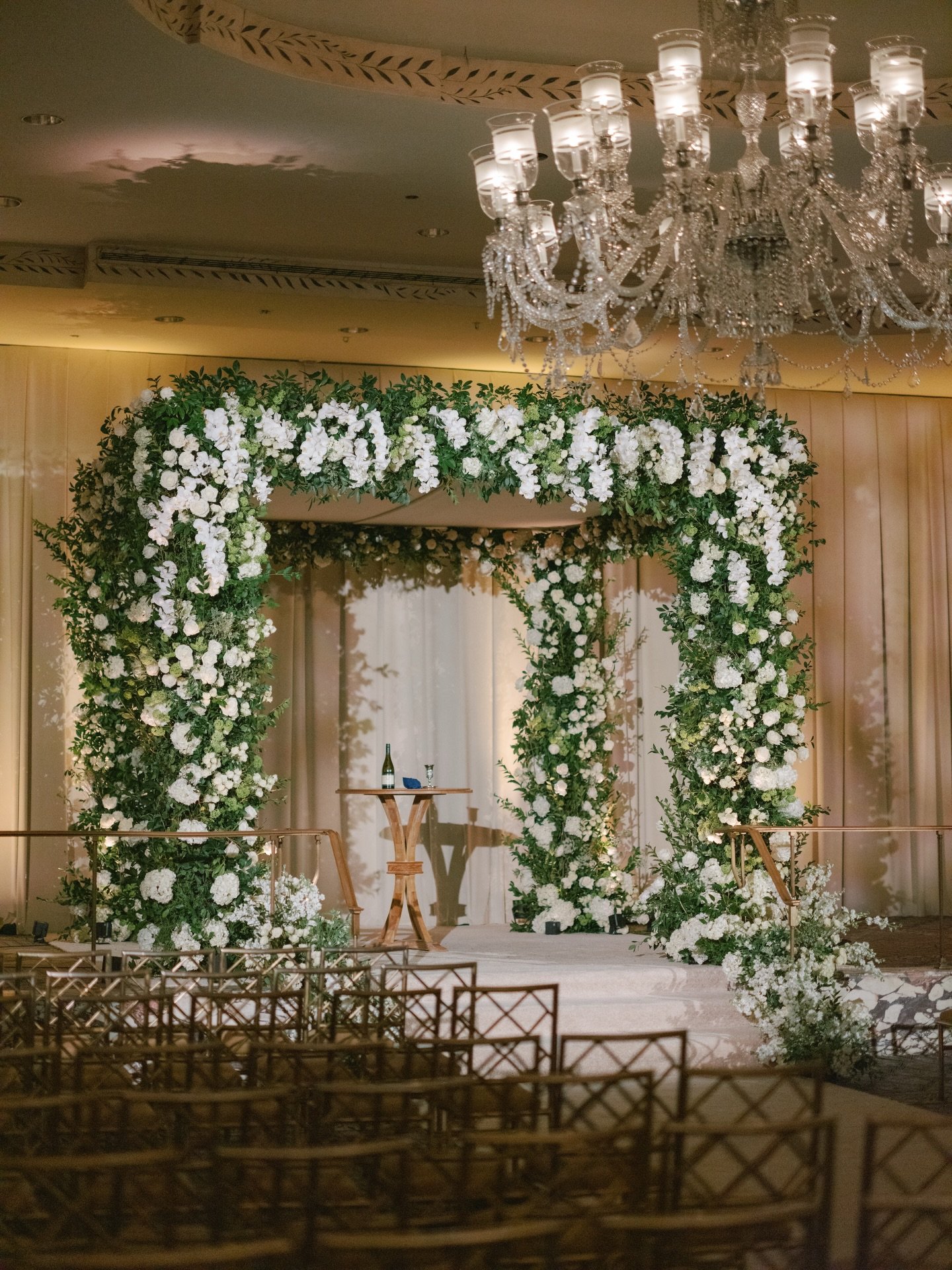 A foundation of soft whites and layered ivories with airy greens, contrasted by taupe draping and echoed in the stationery and escort cards through deeper, textural florals. This is the first part of Sydnie &amp; Zac&rsquo;s wedding. Can&rsquo;t wait