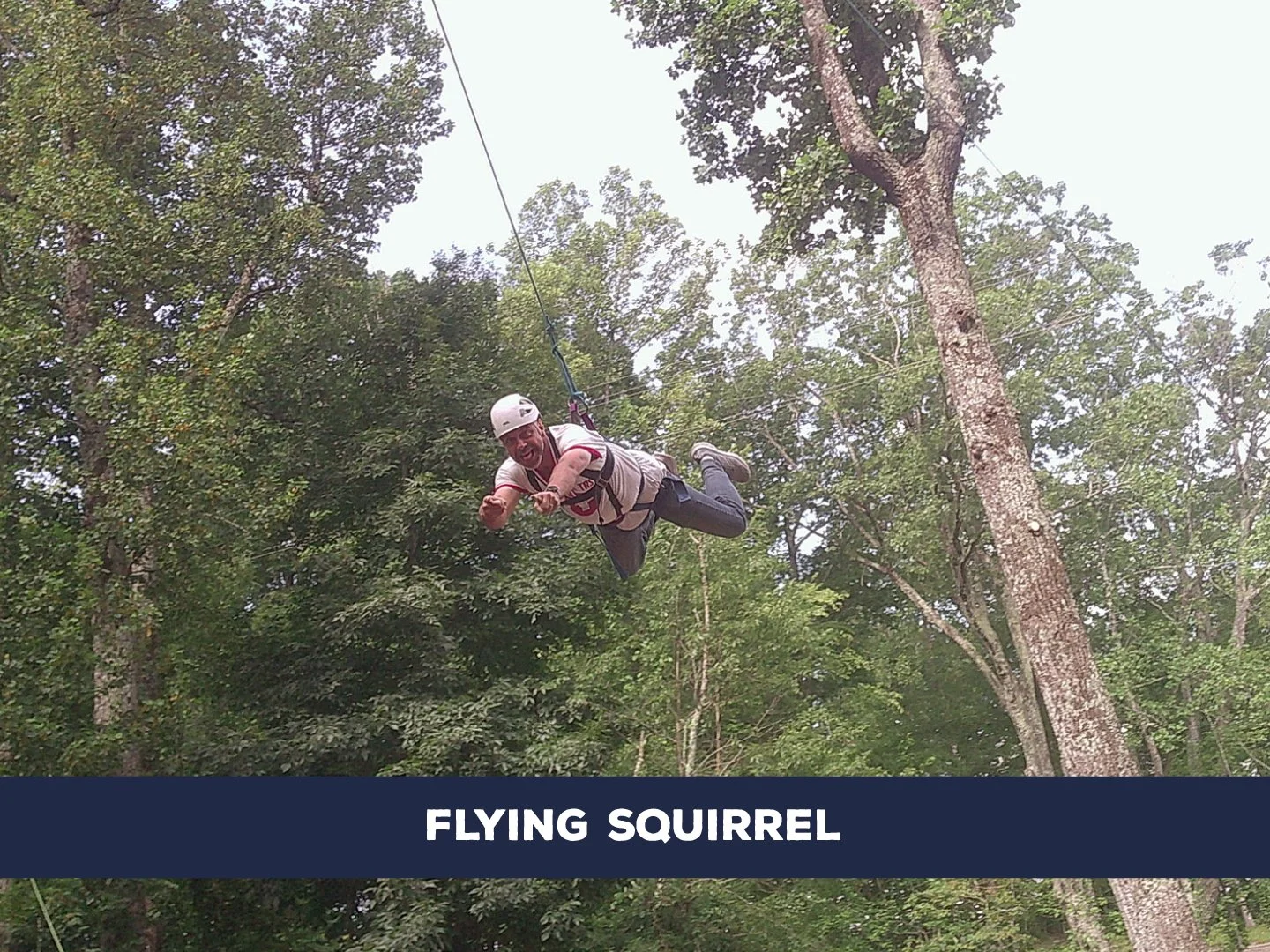 One participant is launched into the air as a team pulls from the opposite side, creating a human-powered flight experience.
