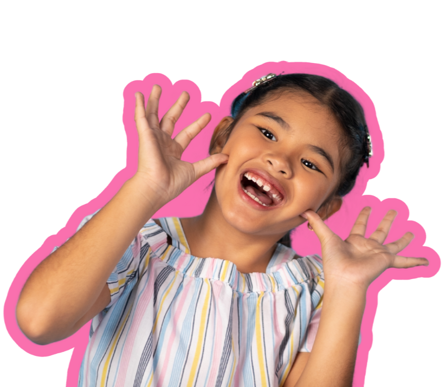 A young girl with dark hair and a big smile, wearing a striped shirt, holding her hands near her head. She is highlighted with a pink outline.