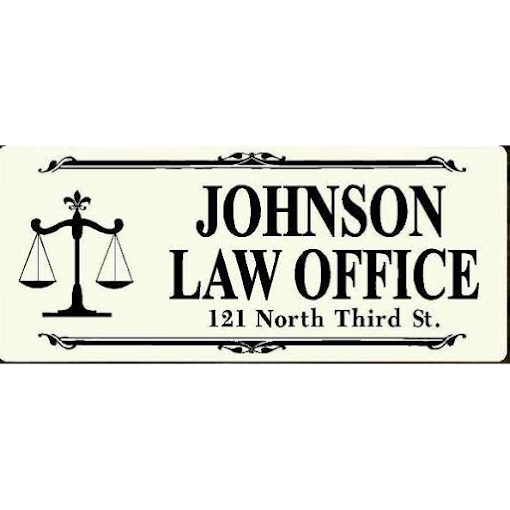 Sign for Johnson Law Office with scales of justice, address 121 North Third Street.