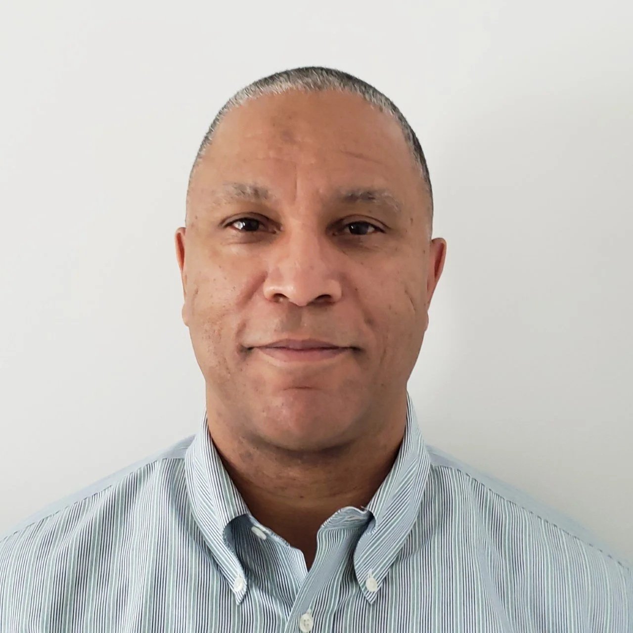 Man smiling a button up shirt.