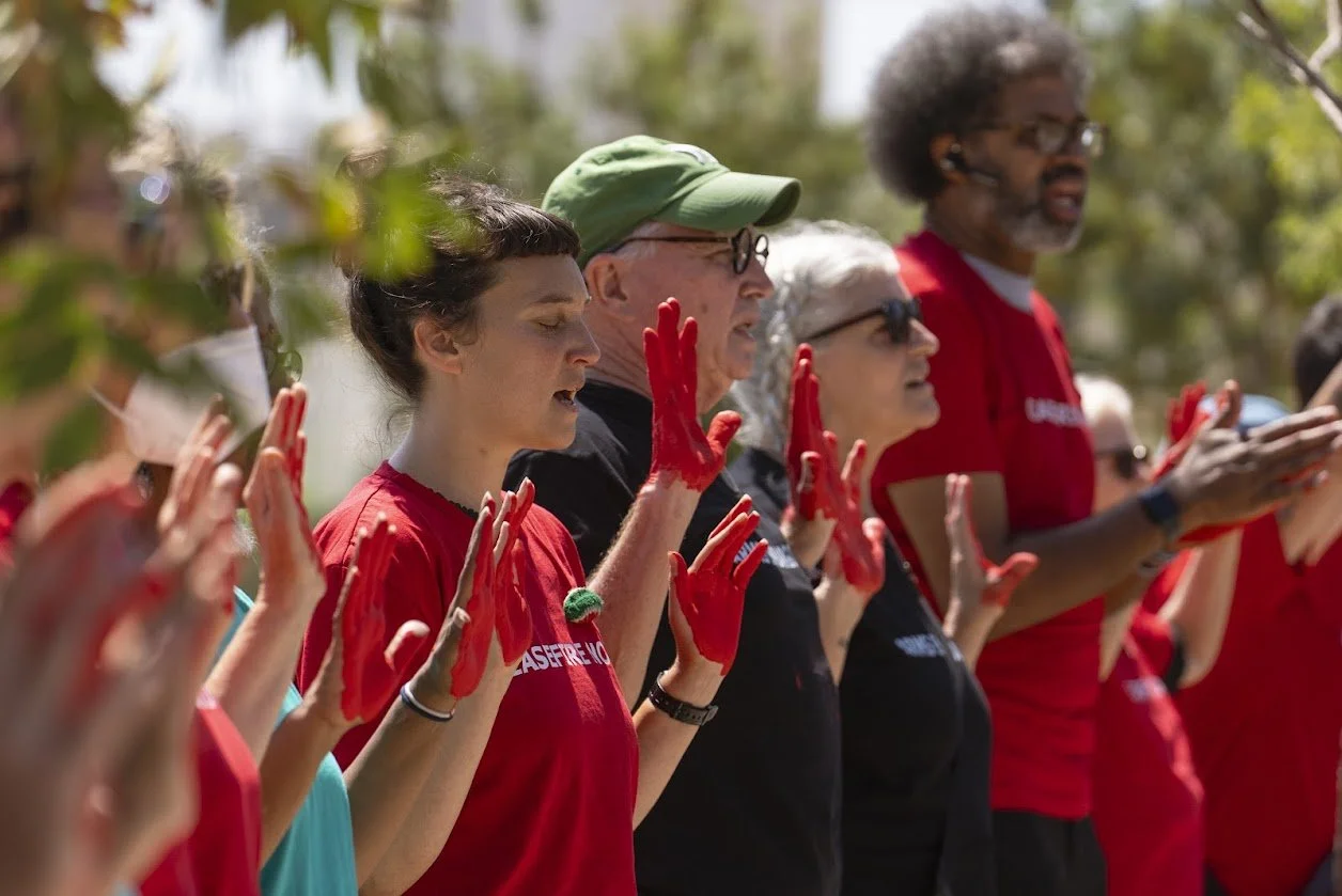 Singing for justice at the U.S. embassy in Jerusalem with "blood" on our hands.