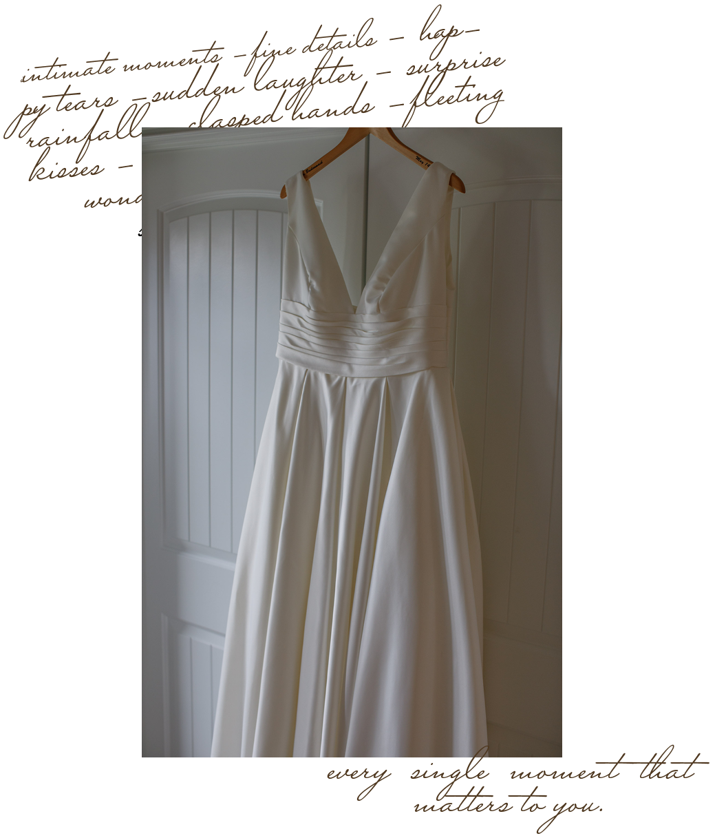 White wedding dress hanging on a wooden hanger in front of white paneled doors.