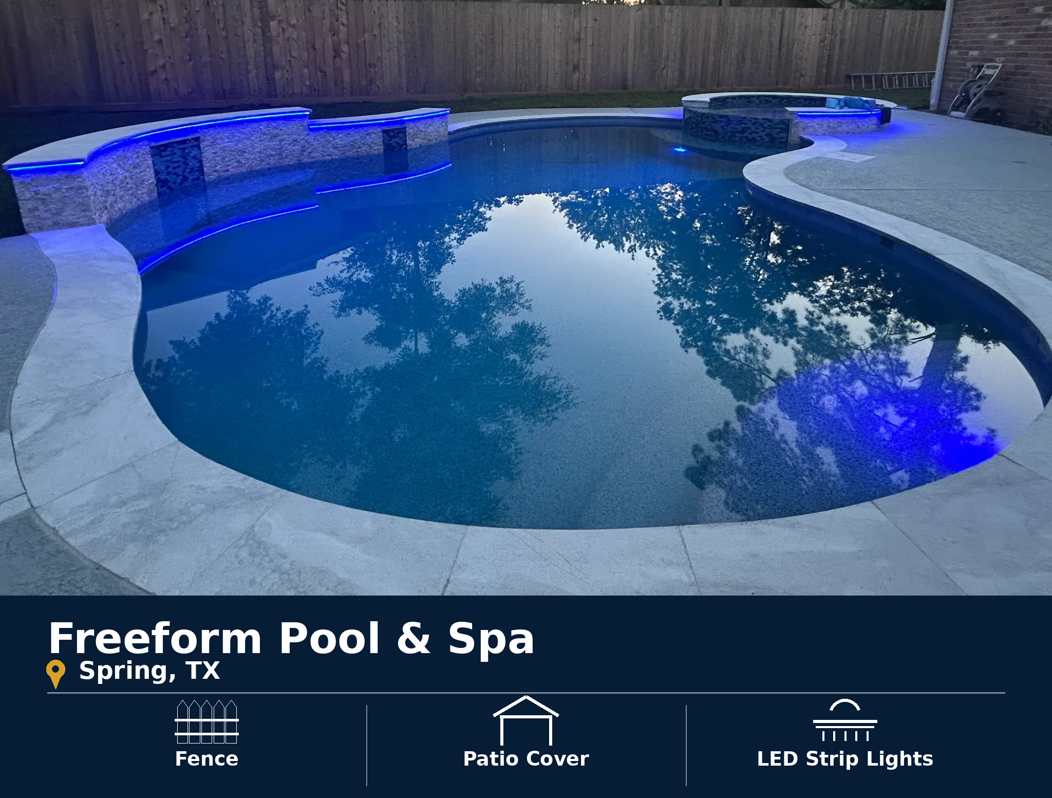 Freeform pool and spa in Spring, TX featuring a privacy fence, patio cover and LED strip lighting.