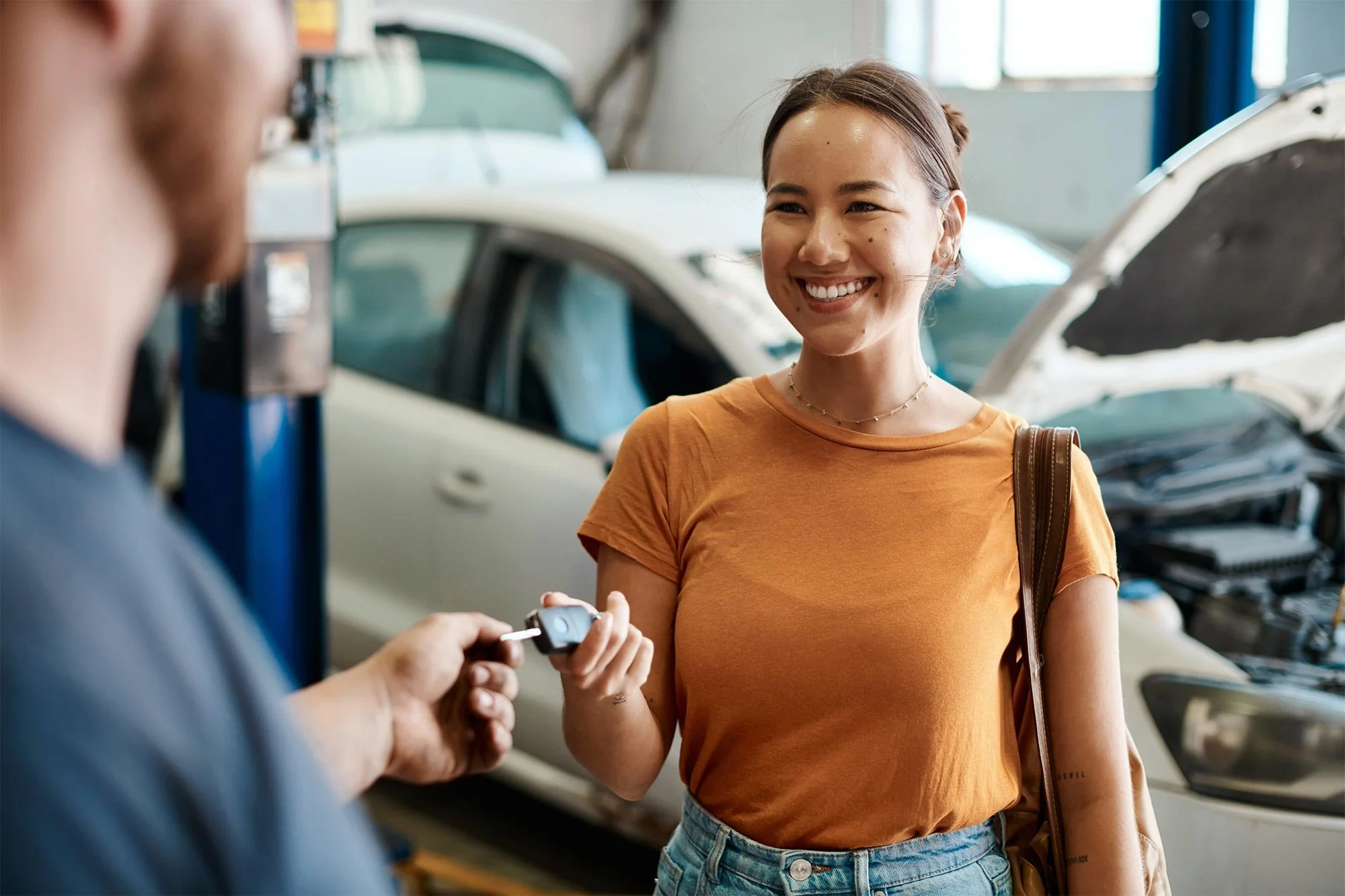 Customer handing keys to mechanic at 107 Auto Repairs Adelaide City