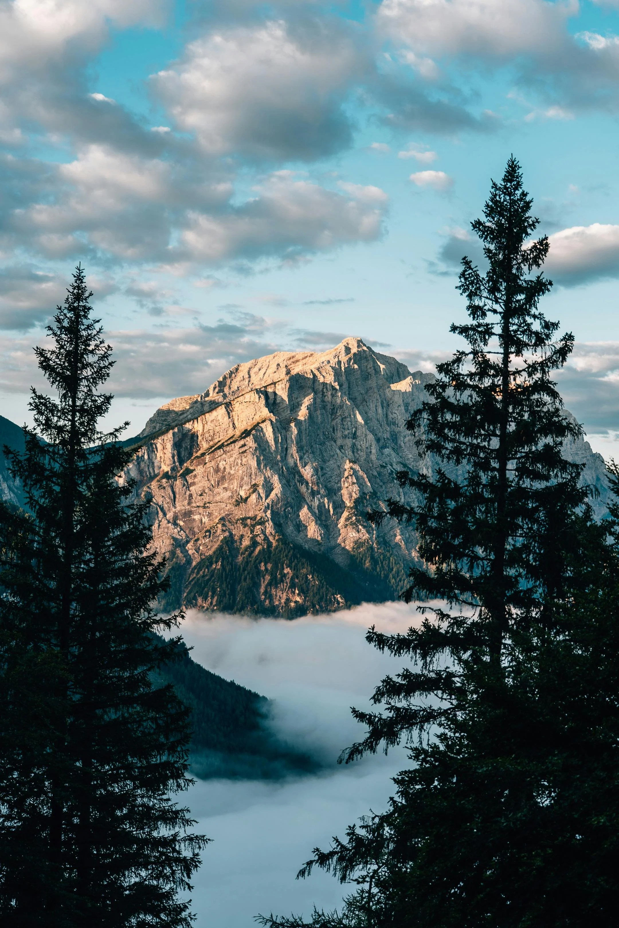 Mountain peak at sunrise with rugged rock formations.