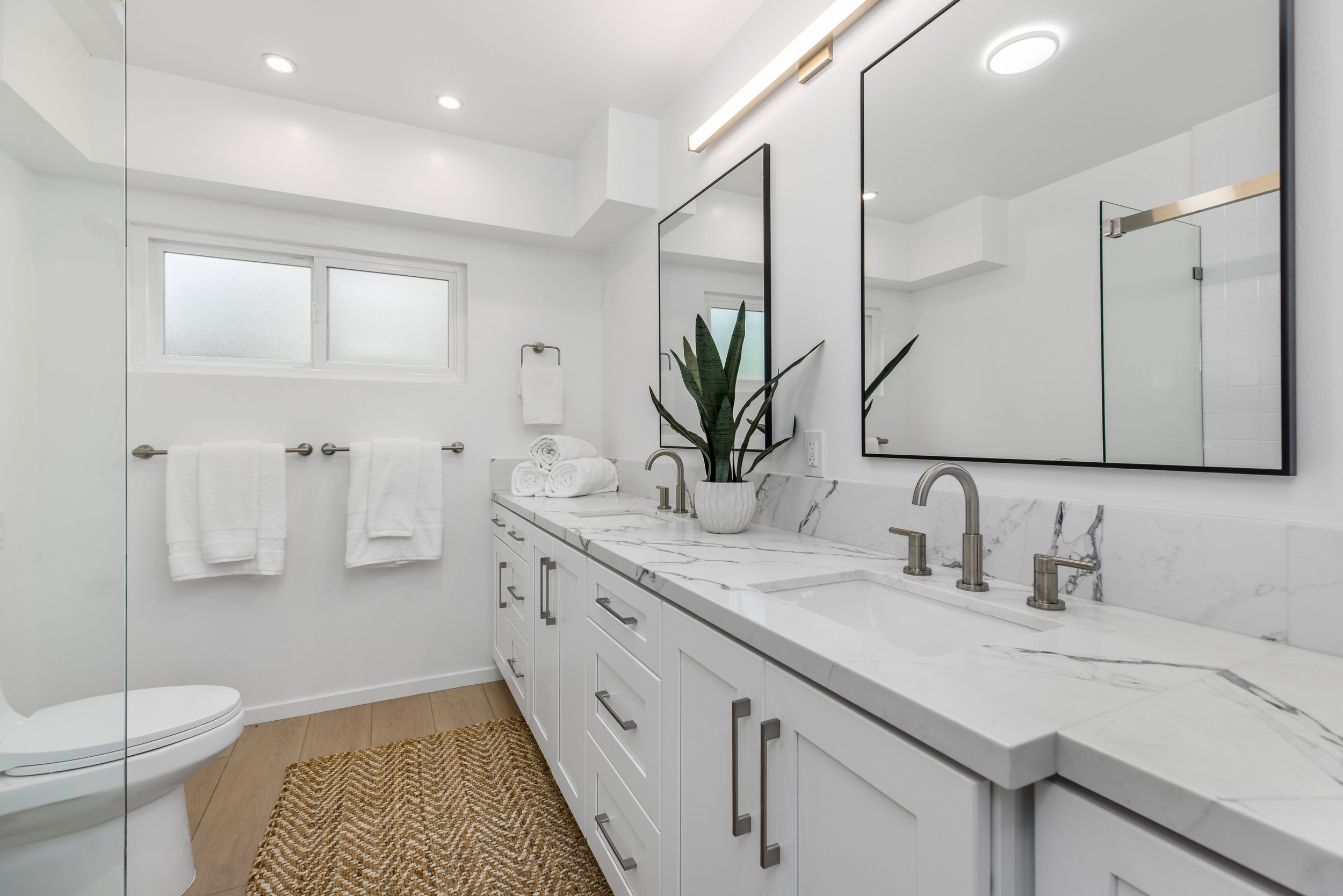 Upgraded and freshly remodeled bathroom with dual sinks