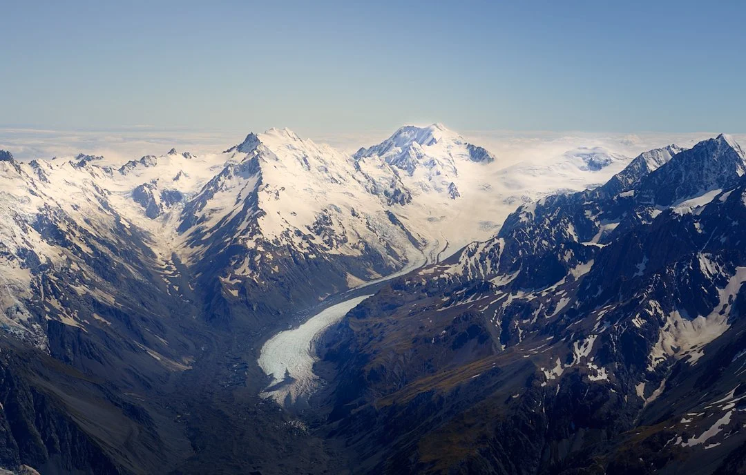 Snow-capped mountains and a glacier in a mountain valley