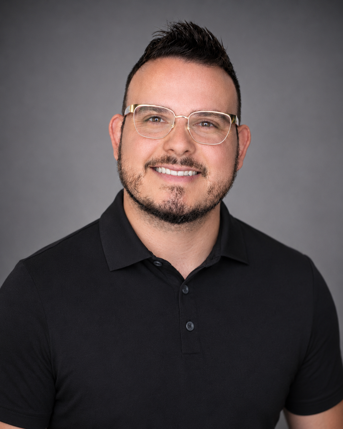 Professional portrait of Pastor Brian Drummond in a black polo shirt.