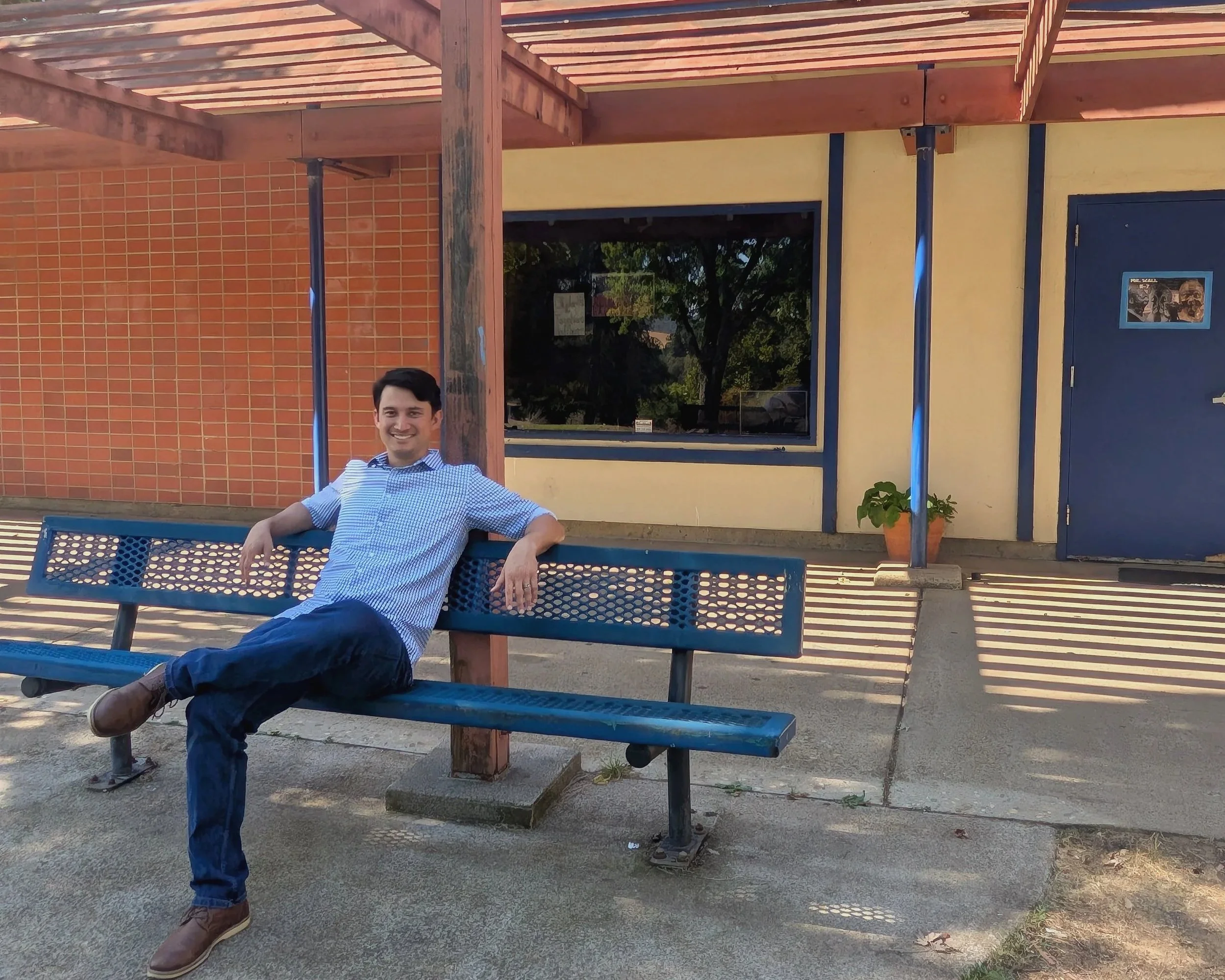 Michael Masuda relaxing on bench.