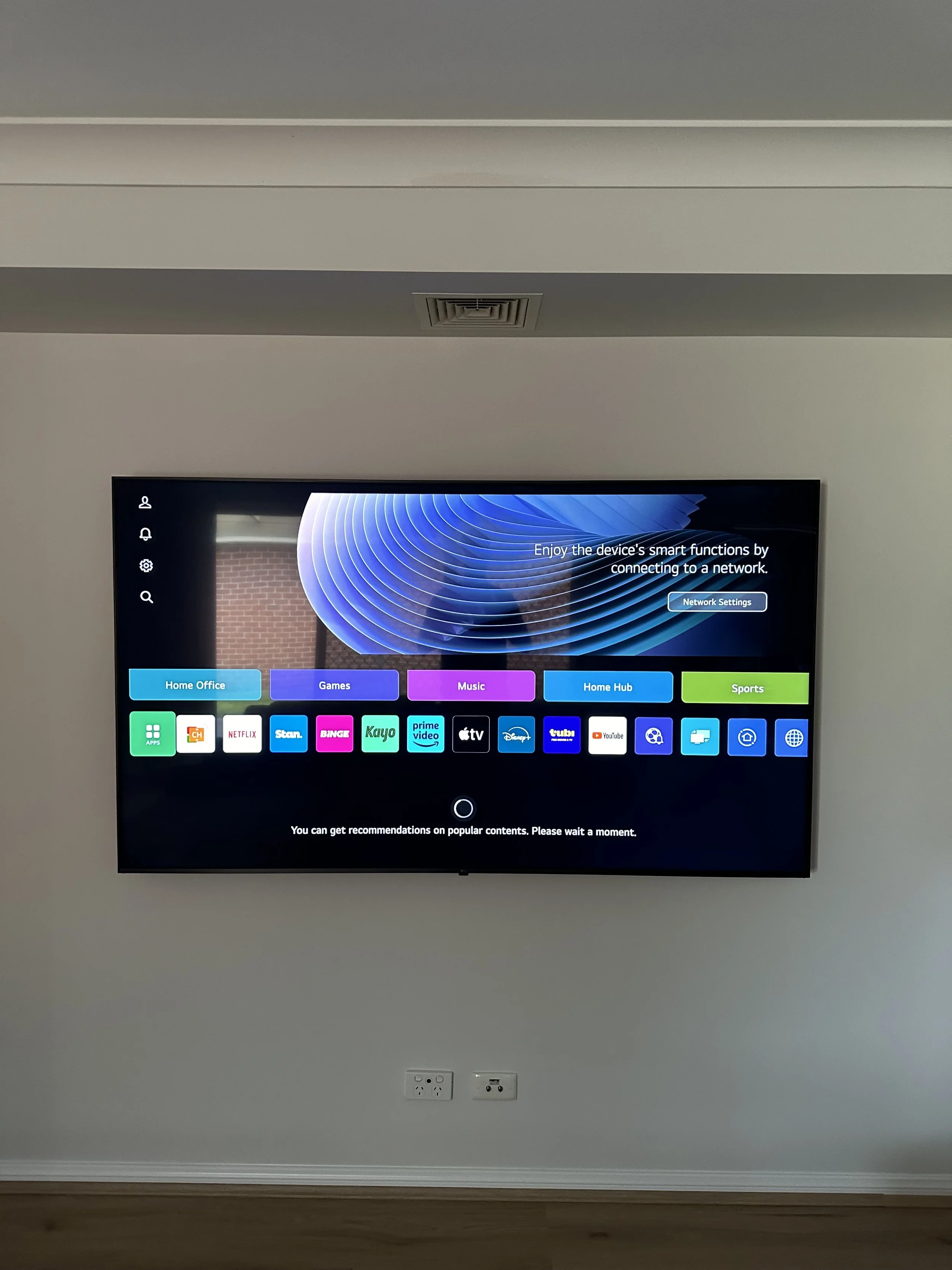 Close-up of a wall-mounted LED light fixture attached to a gray wall.