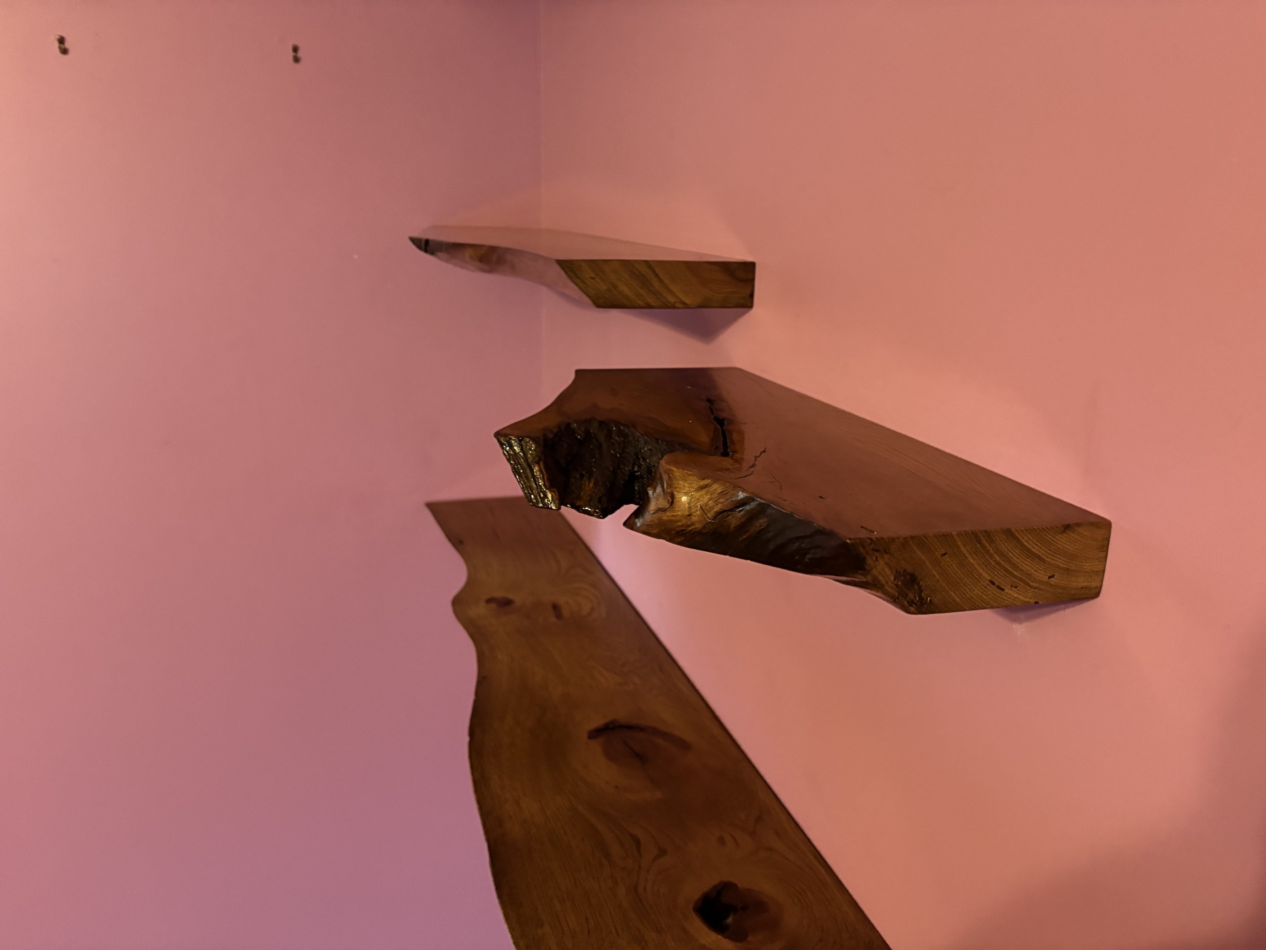 Live edge stained hickory floating shelves.