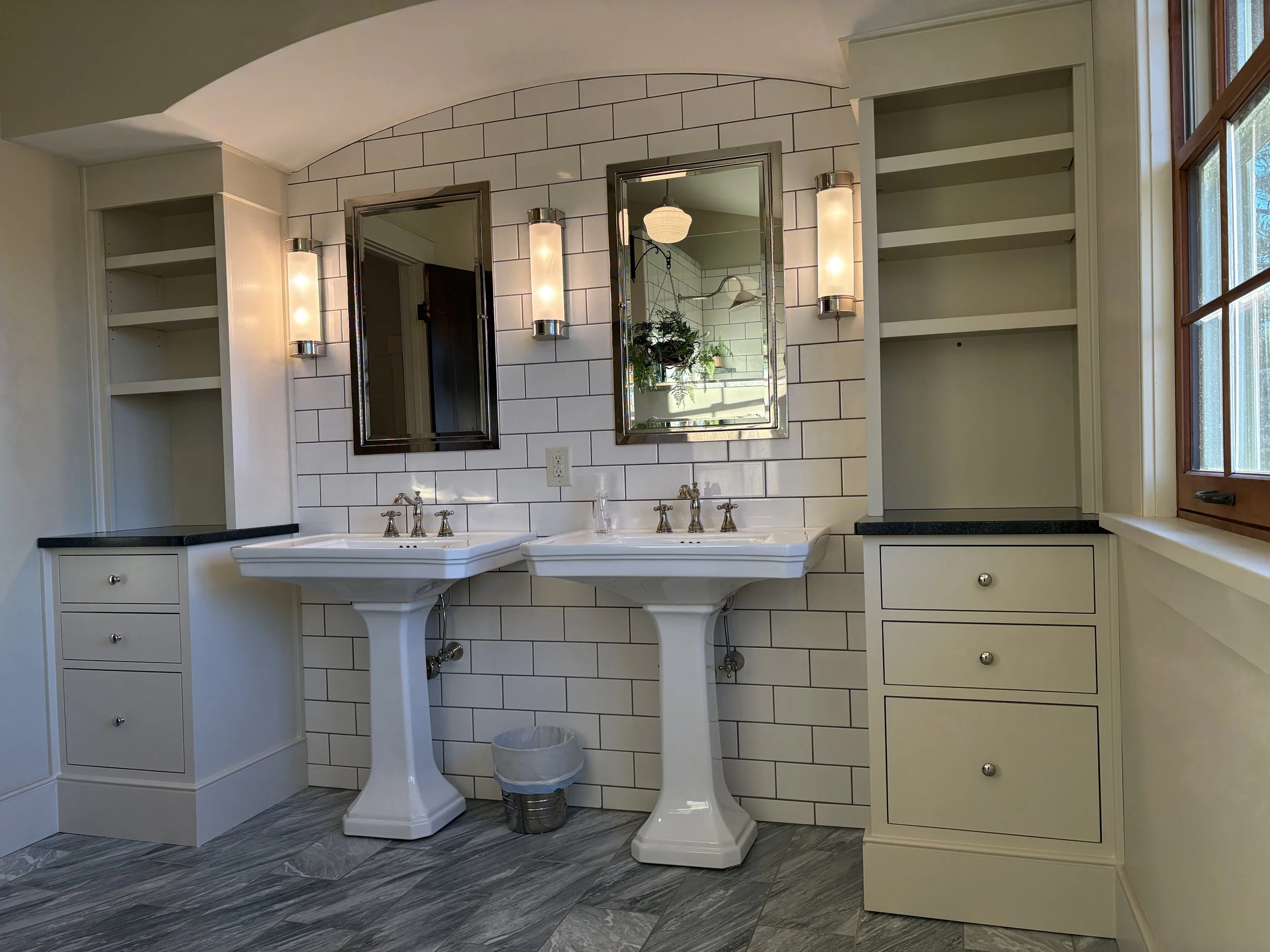 Interior view of a bathroom with white built-in cabinets