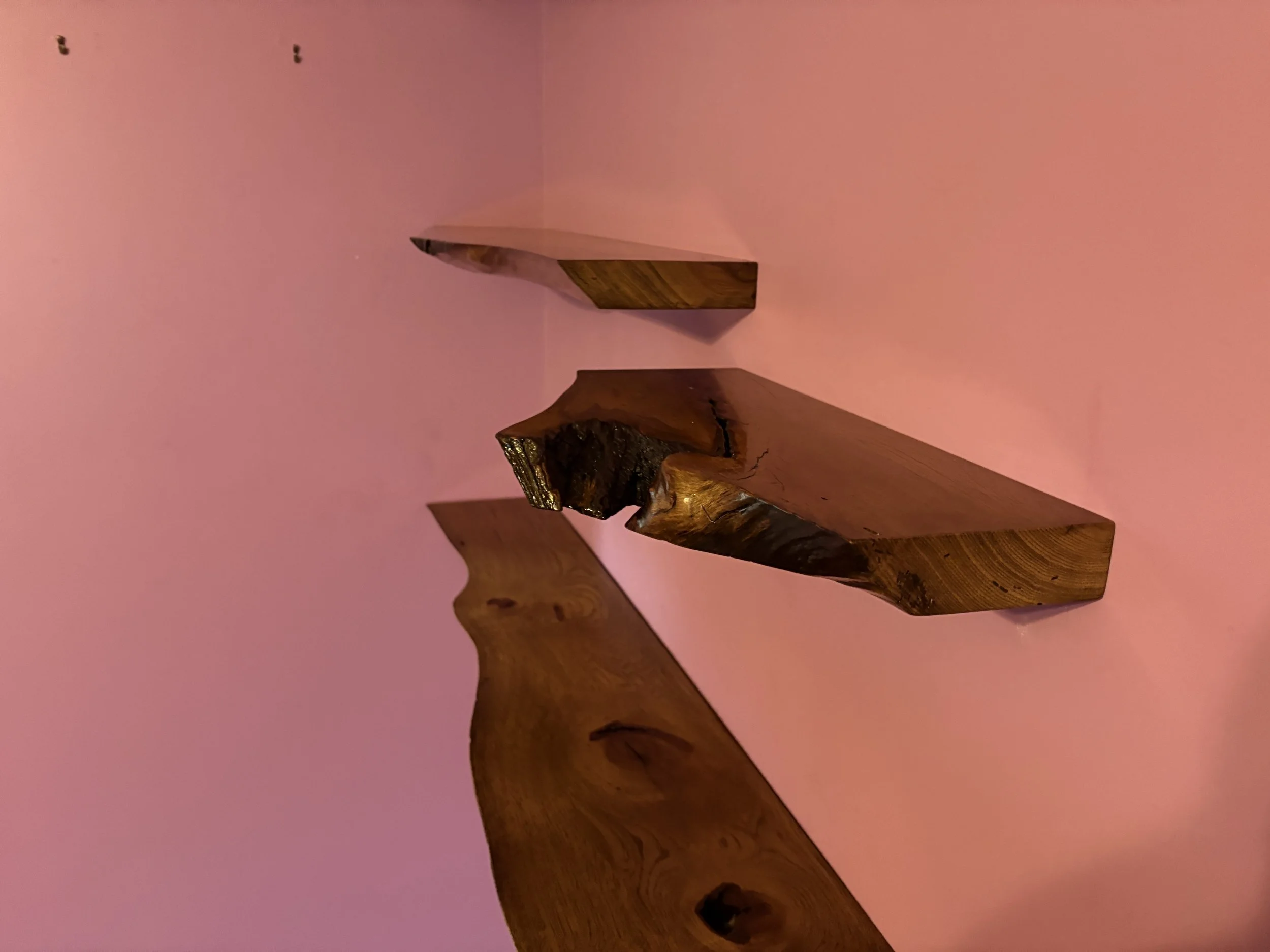 Live edge stained hickory floating shelves.
