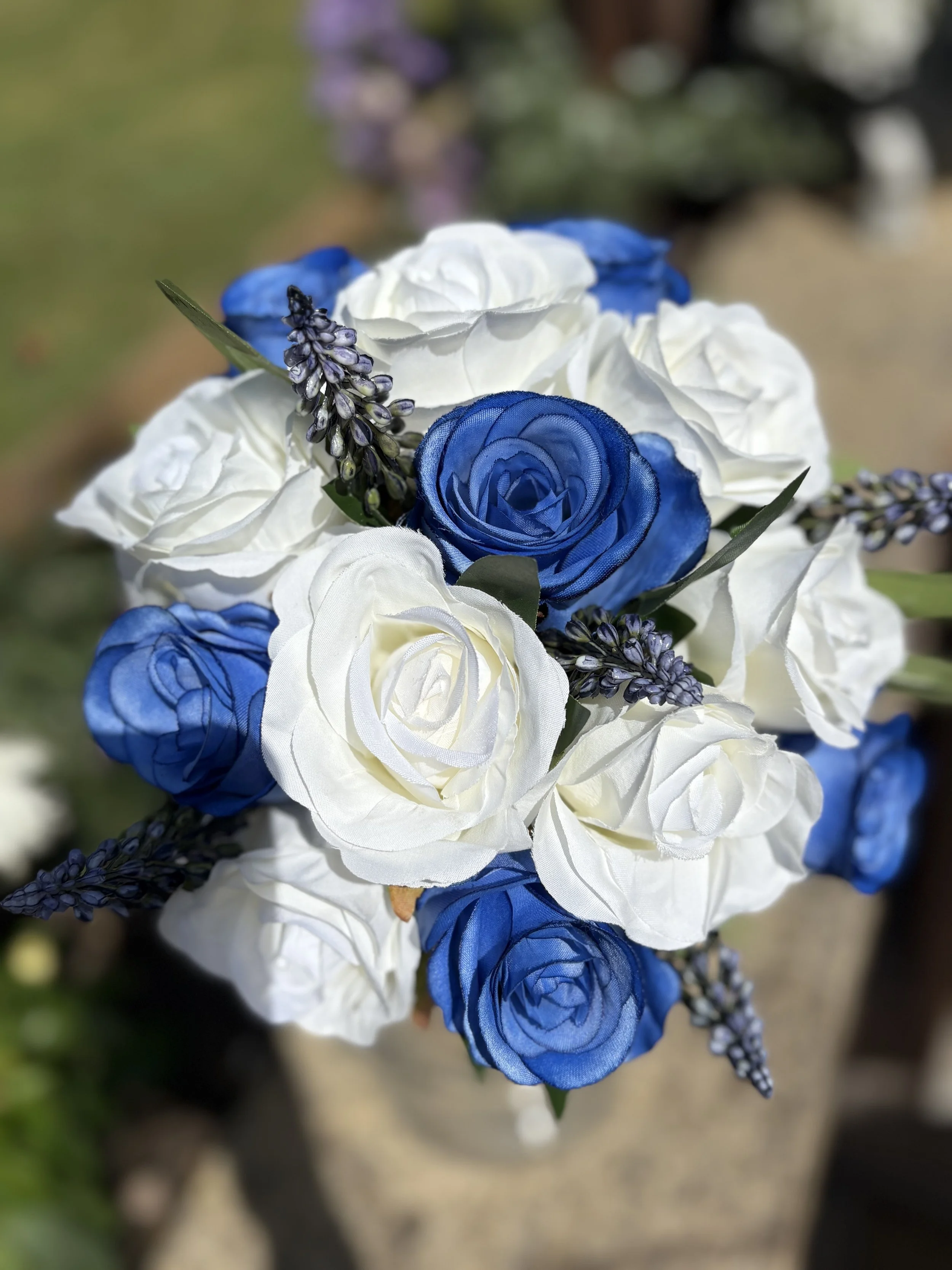 Bouquet of white and blue roses with purple lavender accents