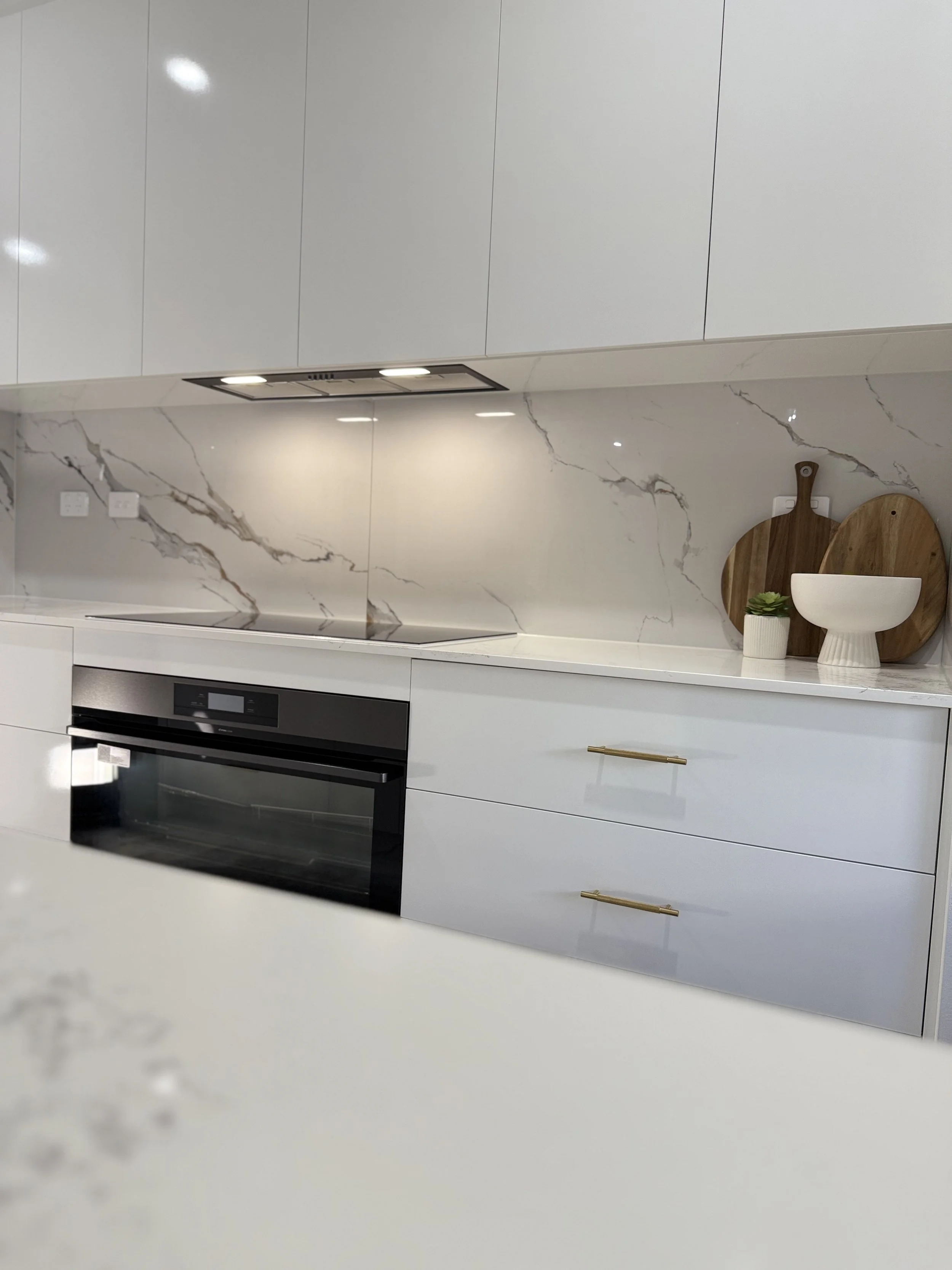 Tiled kitchen splashback behind cooktop in Darwin.